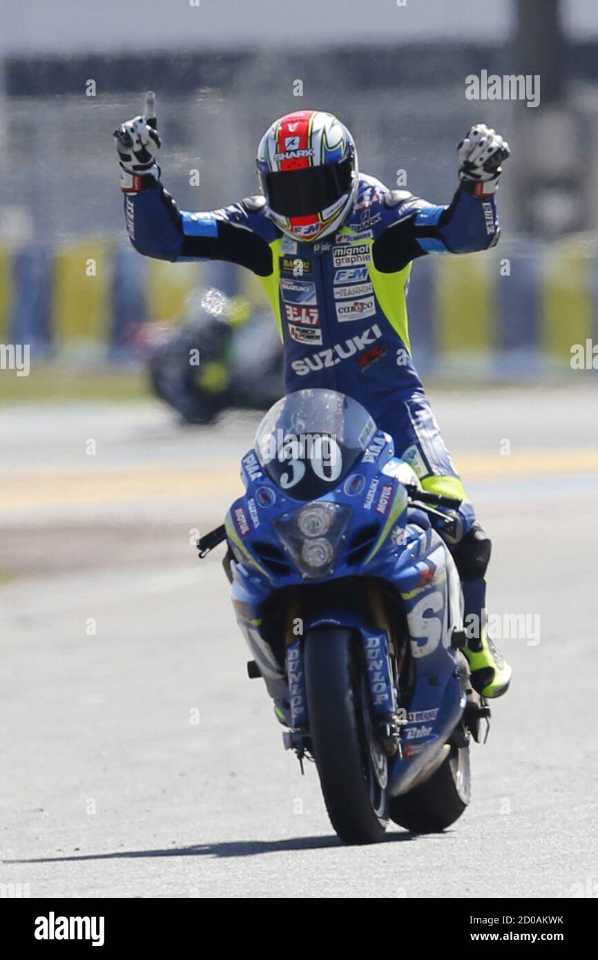 Suzuki rider Vincent Philippe of France celebrates just before crossing the  finish line in first position during the 38th Le Mans 24 Hours motorcycling  endurance race in Le Mans, western France April