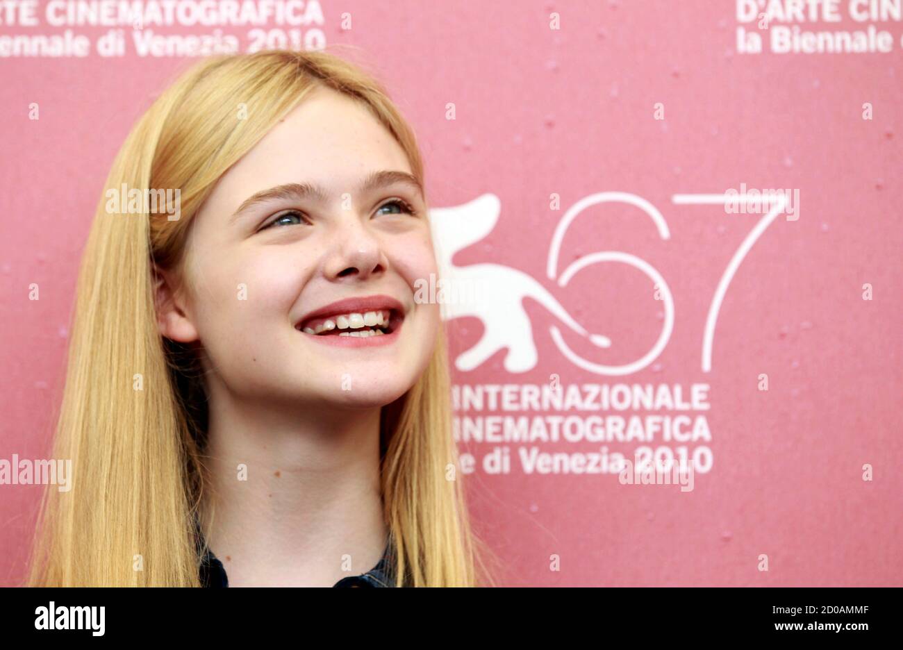 Actress Elle Fanning smiles as she poses during a photocall of in-competition film 'Somewhere' by Sofia Coppola at the 67th Venice Film Festival September 3, 2010.  REUTERS/Alessandro Bianchi   (ITALY - Tags: ENTERTAINMENT HEADSHOT) Stock Photo