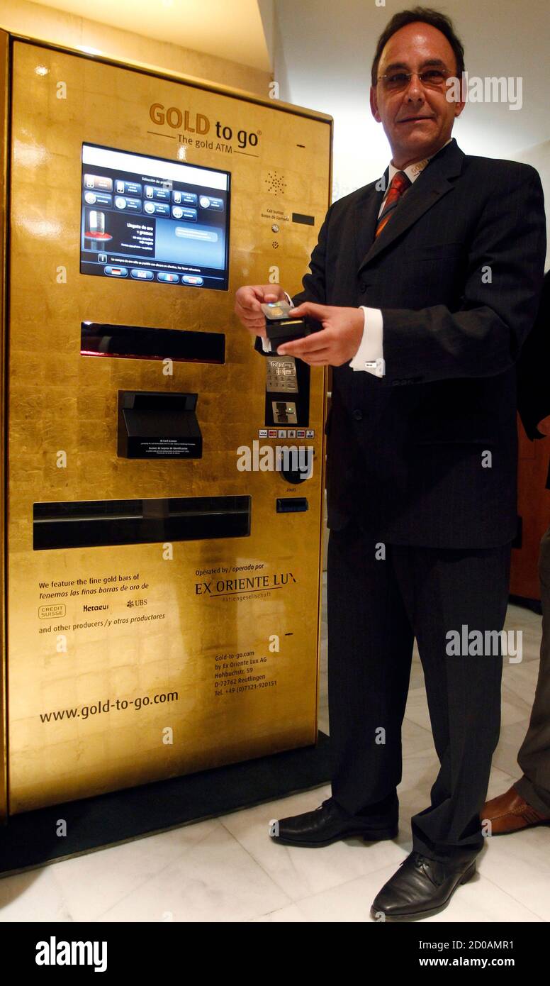 Ex Oriente Lux Ceo Thomas Geissler Holds A Gold Coin After Unveiling The First Gold Plated Atm Automated Teller Machine In Europe At A Madrid S Luxury Hotel September 23 2010 The Machine Which