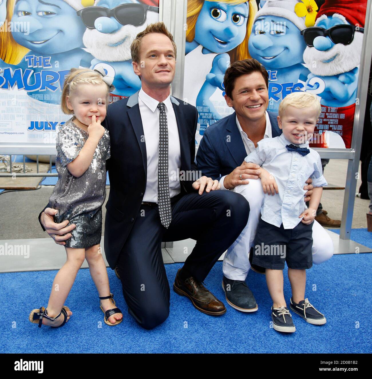Cast member Neil Patrick Harris (L) and his partner David Burtka pose with  their twins Gideon Scott and Harper Grace, at the premiere of the film "The  Smurfs 2" at the Regency
