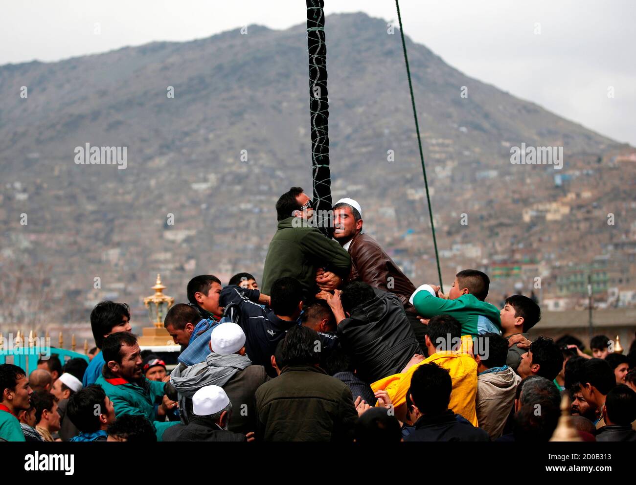 Afghans try to touch and kiss a religious flag to celebrate the Afghan New  Year (Newroz) in Kabul March 21, 2014. Afghanistan uses the Persian calendar  which runs from the vernal equinox.