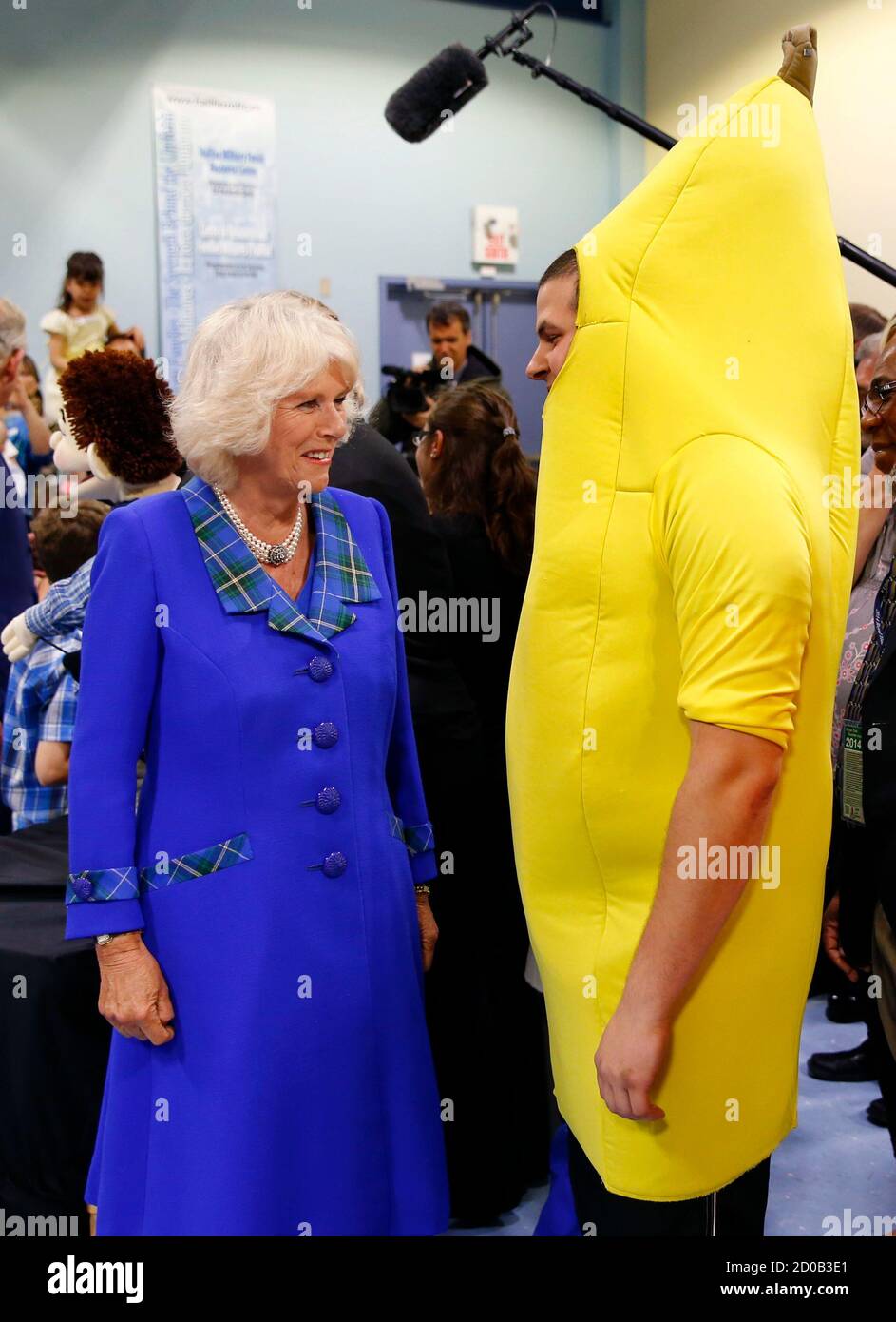 Britain's Camilla, Duchess of Cornwall (L), greets a man dressed as a  banana during a visit to the Military Family Resource Centre in Halifax,  Nova Scotia, May 19, 2014. Puppets and costumes