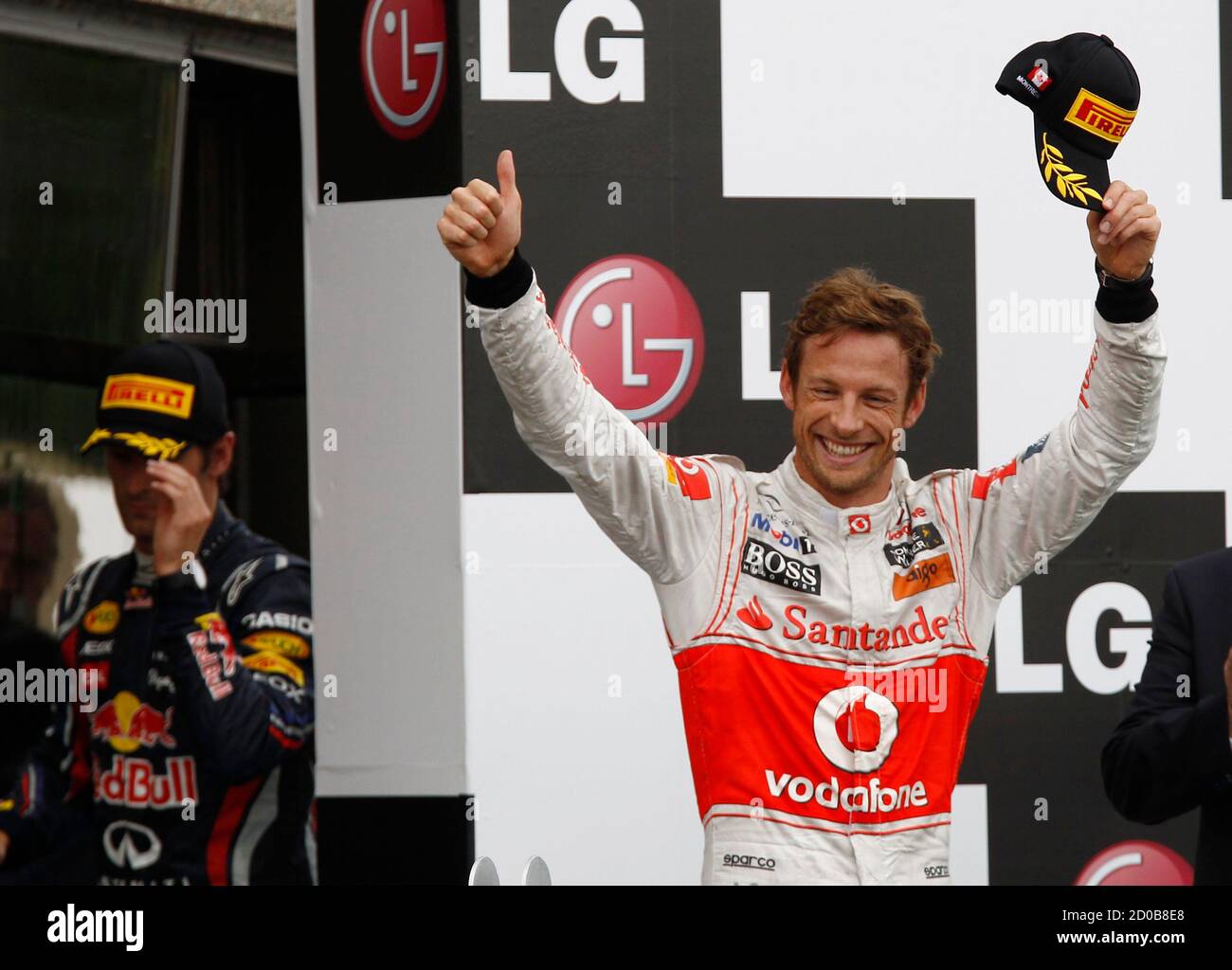 McLaren Formula One driver Jenson Button of Britain celebrates winning the Canadian F1 on the podium during the Grand Prix at the Circuit Gilles Villeneuve in Montreal June 12, 2011.   REUTERS/Chris Wattie (CANADA  - Tags: SPORT MOTOR RACING) Stock Photo