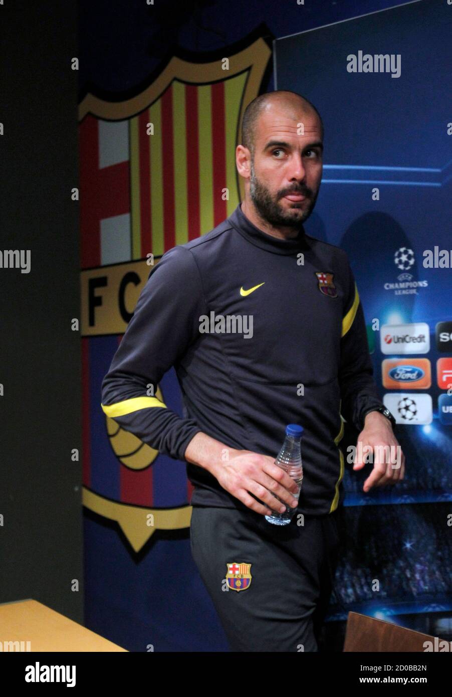 Barcelona's coach Pep Guardiola arrives for a news conference at Camp Nou stadium in Barcelona, April 2, 2012. Barcelona will play against AC Milan in their Champions League soccer match second leg on Tuesday. REUTERS/Albert Gea (SPAIN - Tags: SPORT SOCCER) Stock Photo