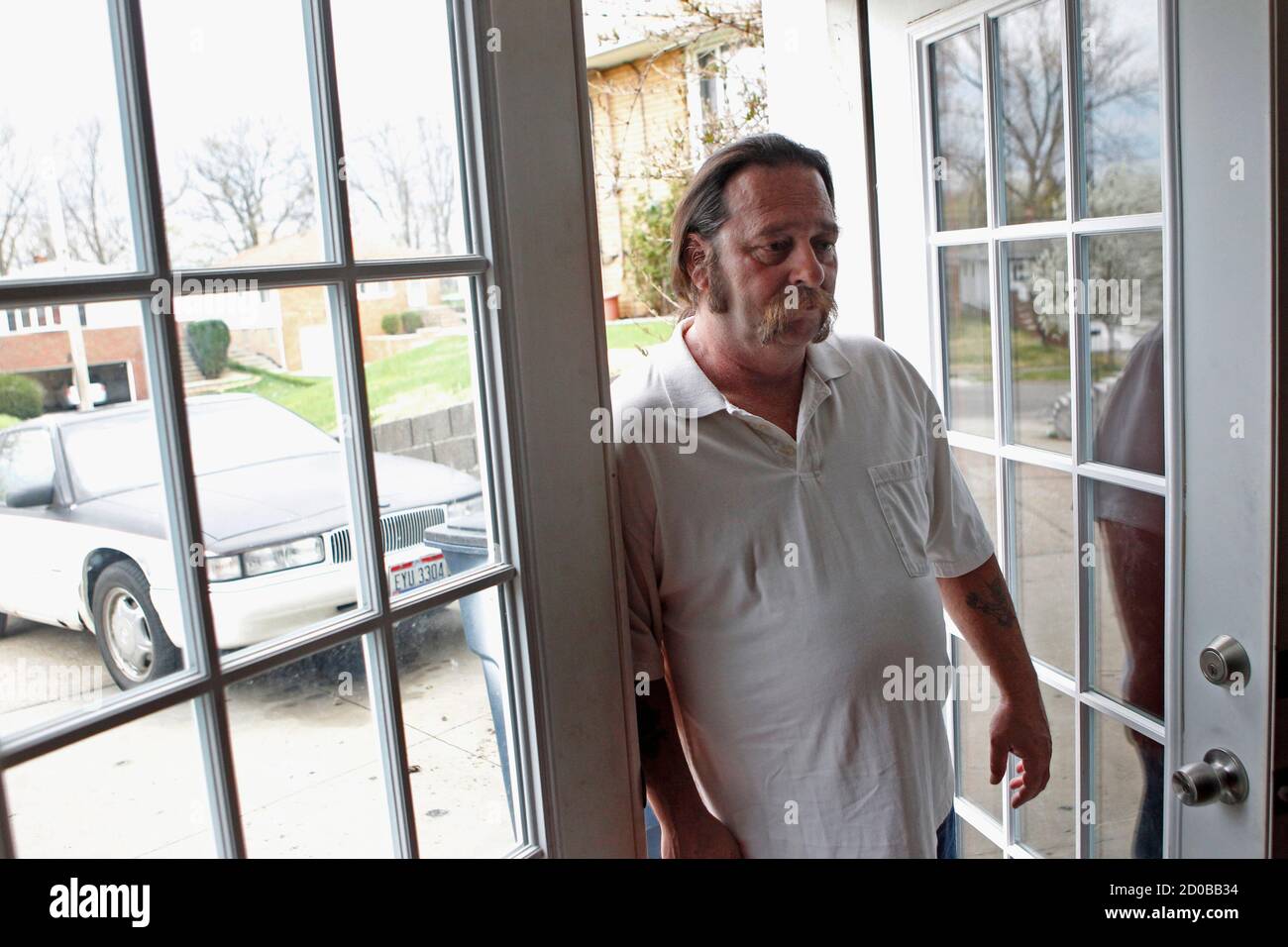 Daniel Burns, 52, stands in the doorway of his home in Garfield Heights, Ohio March 23, 2012. Unable to cover his mortgage, Burns received a grant from a government fund using money repaid from the 2008 bank bailout. Half a decade into the deepest U.S. housing crisis since the 1930s, many Americans are hoping the crisis is finally nearing its end. But a painful part two of the slump looks set to unfold: Many more U.S. homeowners face the prospect of losing their homes this year as banks pick up the pace of foreclosures. Picture taken March 23, 2012. To match Feature USA-HOUSING/FORECLOSURES    Stock Photo
