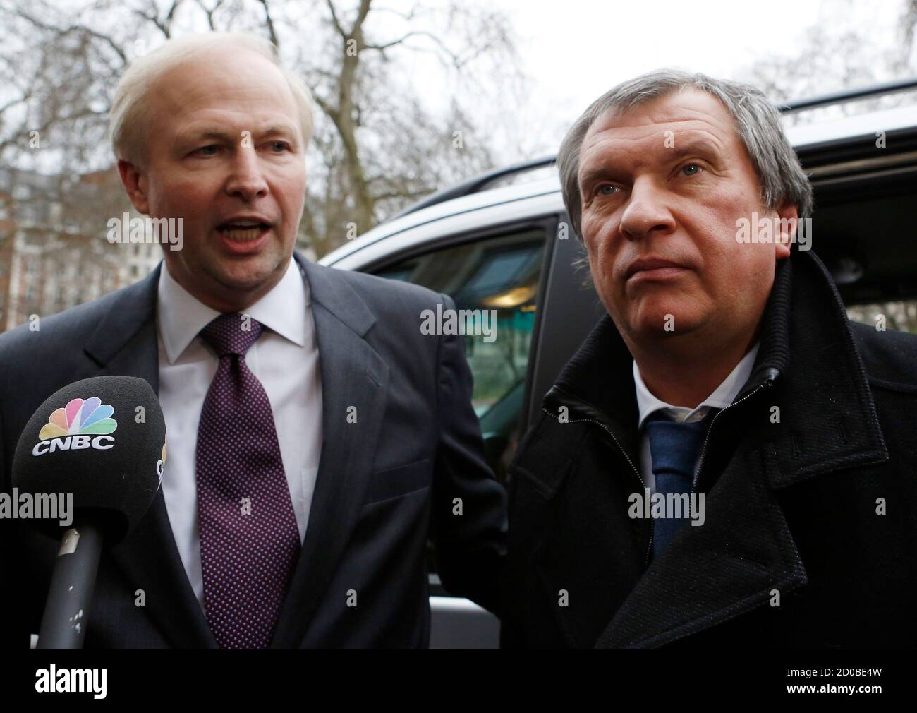 British Petroleum CEO Bob Dudley (L) and Rosneft CEO Igor Sechin speak to journalists as they arrive outside the BP headquarters in central London March 21, 2013. Russian state oil company Rosneft closed its deal to buy TNK-BP from UK-based BP and four tycoons on Thursday, releasing $40 billion cash to the sellers and becoming a bigger oil producer than Exxon Mobil. The $55 billion deal, which also gives BP a near 20 percent stake in Rosneft, was announced last year after months of on-off negotiations. It is the biggest in Russia's corporate history.. REUTERS/Olivia Harris (BRITAIN - Tags: BUS Stock Photo