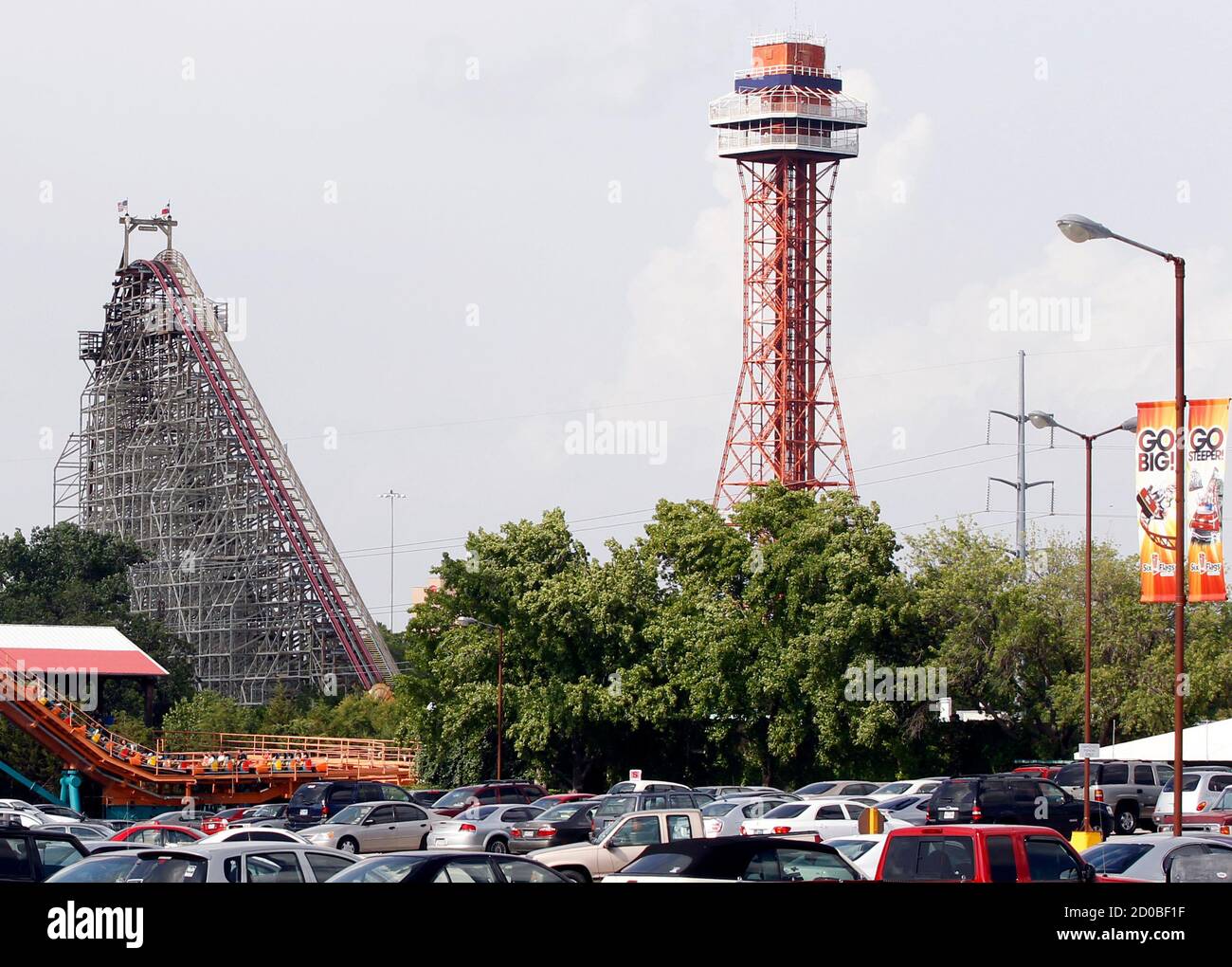 The Texas Giant roller coaster ride (L) is seen at the Six Flags Over Texas amusement park in Arlington, Texas July 23, 2013.  A woman who plunged from the Texas Giant roller coaster ride at the Six Flags Over Texas amusement park died of multiple traumatic injuries in a fall that was ruled an accident, authorities said on Monday.  REUTERS/Mike Stone (UNITED STATES - Tags: SOCIETY) Stock Photo