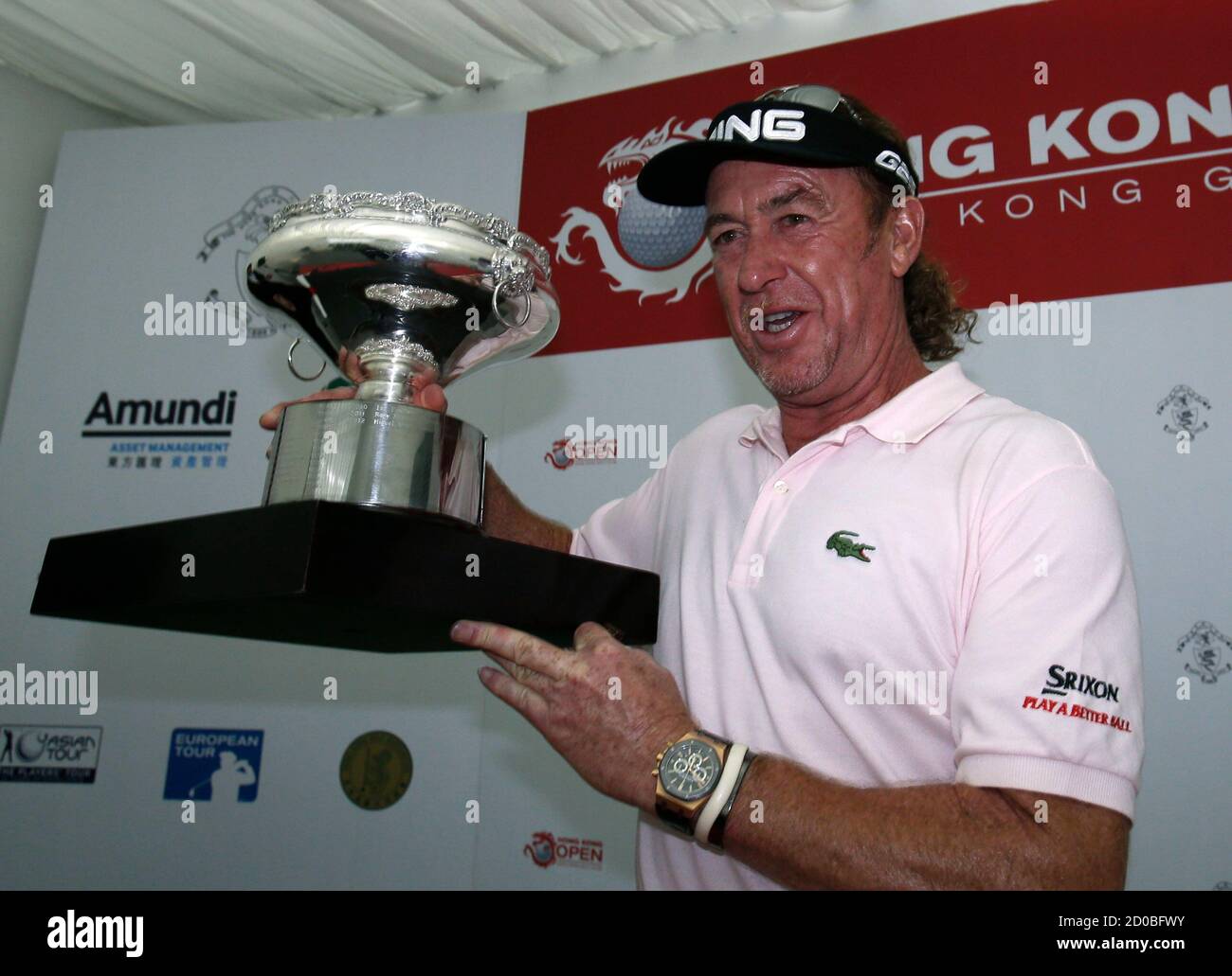 Defending champion Miguel Angel Jimenez of Spain celebrates with his trophy  after winning the European Tour Hong Kong Open golf tournament through a  playoff in Hong Kong December 8, 2013. REUTERS/Bobby Yip (