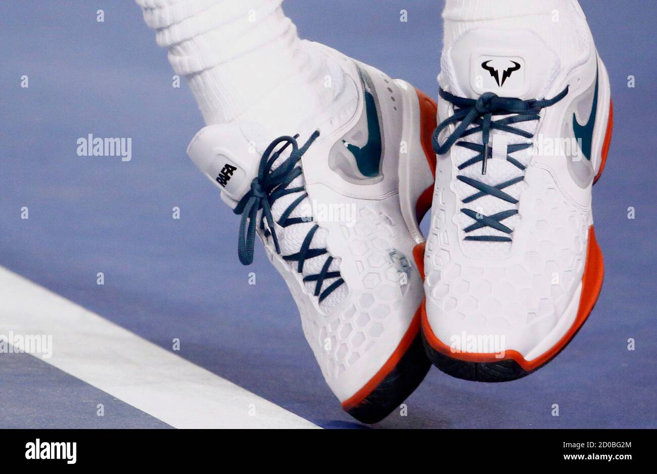 The word "Rafa" and the logo of a bull are seen on Rafael Nadal of Spain's  pair of Nike shoes as he serves to Thanasi Kokkinakis of Australia during  their men's singles