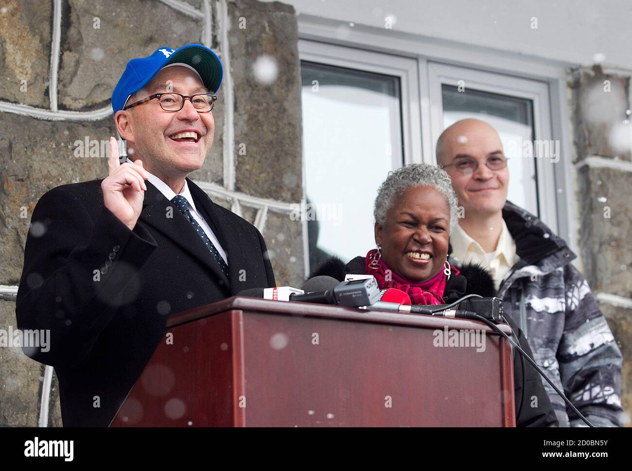 David Jacobson (L), U.S. Ambassador to Canada wearing a Montreal Royals  baseball cap speaks to the crowd as Sharon Robinson (C), daughter of late  baseball player Jackie Robinson looks on prior to