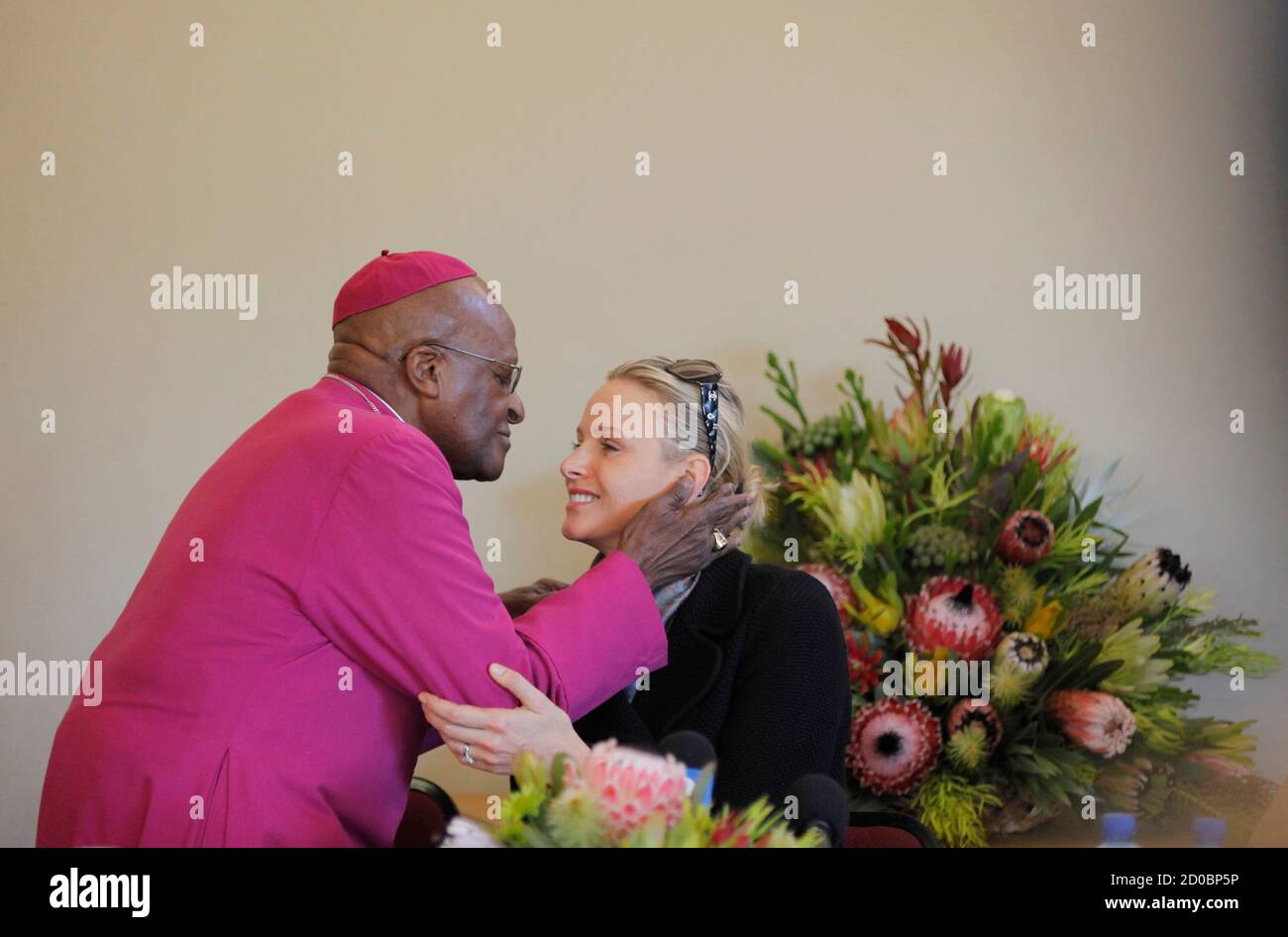 Archbishop Desmond Tutu welcomes Princess Charlene of Monaco during a visit  to the Desmond Tutu HIV Foundation youth centre in Masiphelele township  near Cape Town, July 8, 2011. REUTERS/Mike Hutchings (SOUTH AFRICA -