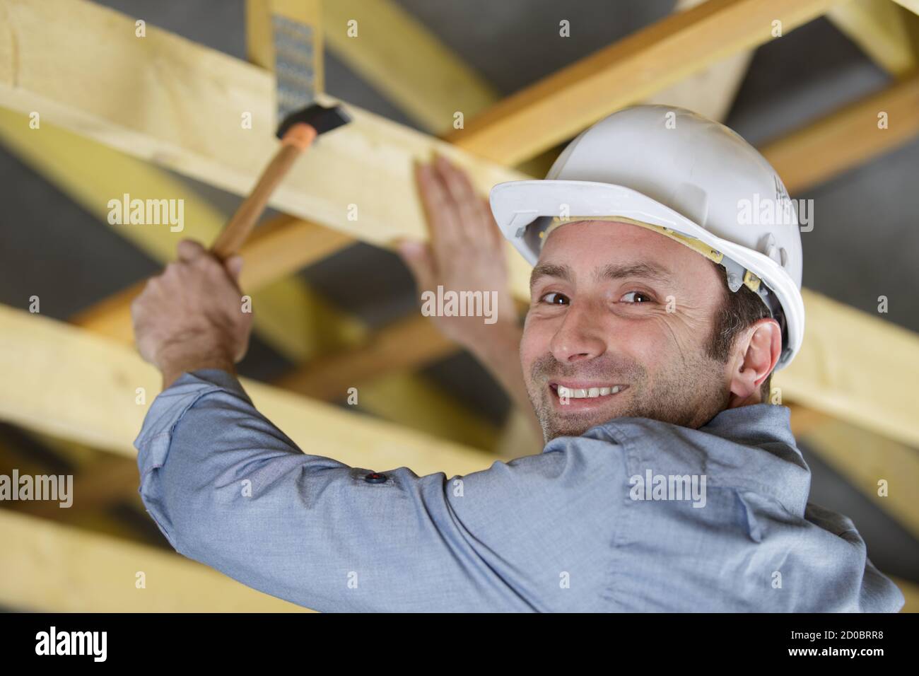 worker roofer builder working on roof structure on construction site