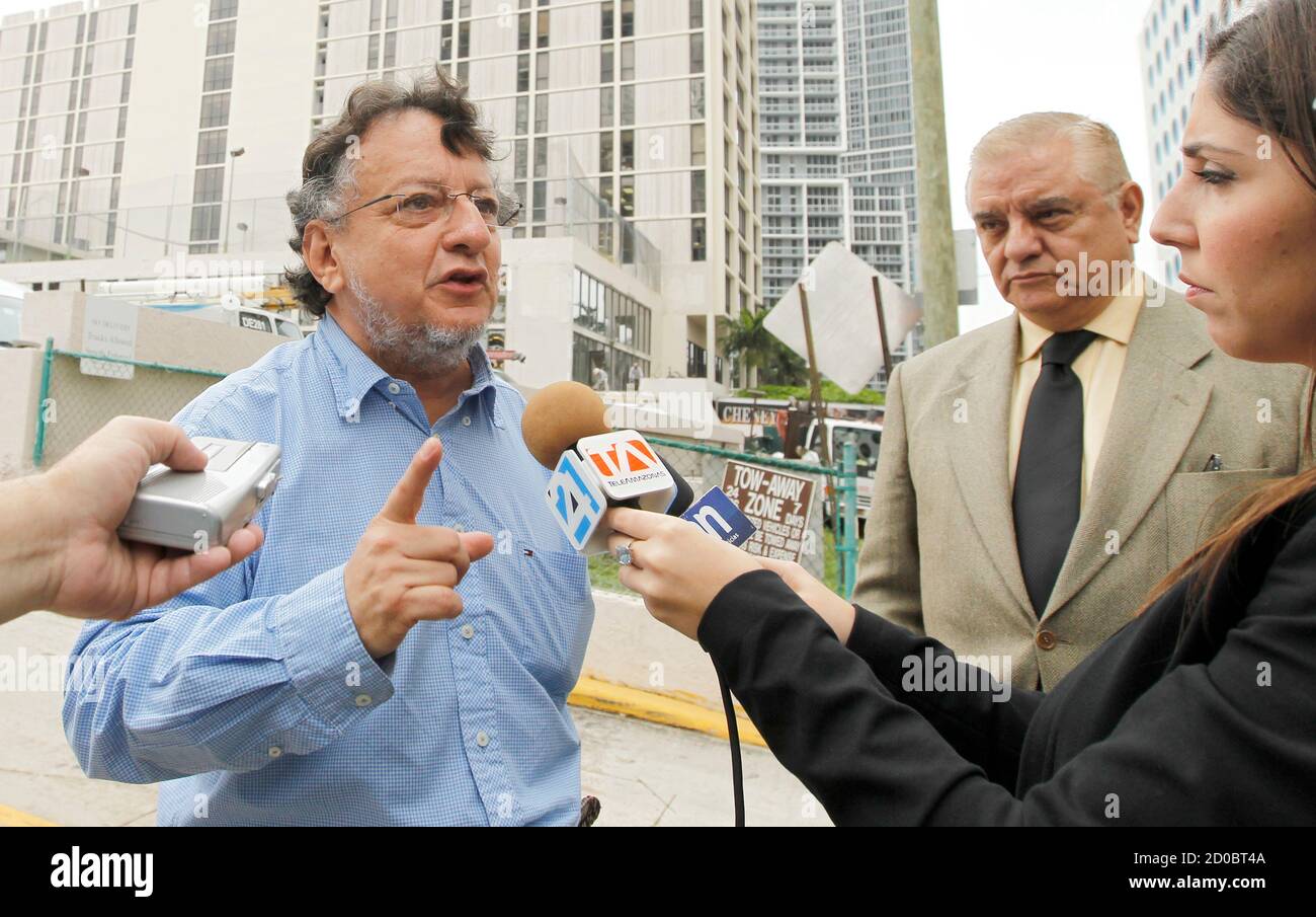 Ecuadorean newspaper columnist Emilio Palacio (L) speaks with the media as his Ecuadorian attorney Jorge Alvear looks on after their meeting with officials at the U.S. Immigration Services Asylum Office in Miami, Florida February 8, 2012. Palacio pleaded his case for asylum with U.S. immigration officials on Wednesday, claiming he is a victim of political persecution after he was sentenced to jail and ordered to pay millions of dollars in damages in Ecuador for criticizing Ecuador's President Rafael Correa. REUTERS/Joe Skipper (UNITED STATES - Tags: POLITICS CRIME LAW) Stock Photo