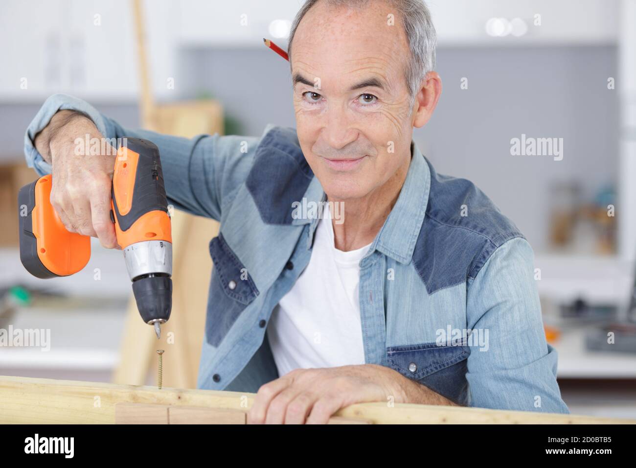 man drilling wood at home Stock Photo