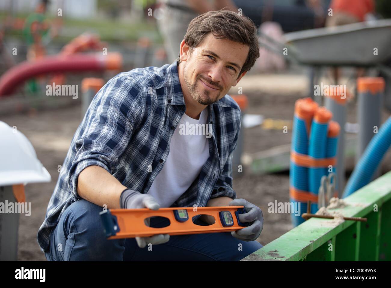 workman using spirit level on construction site Stock Photo