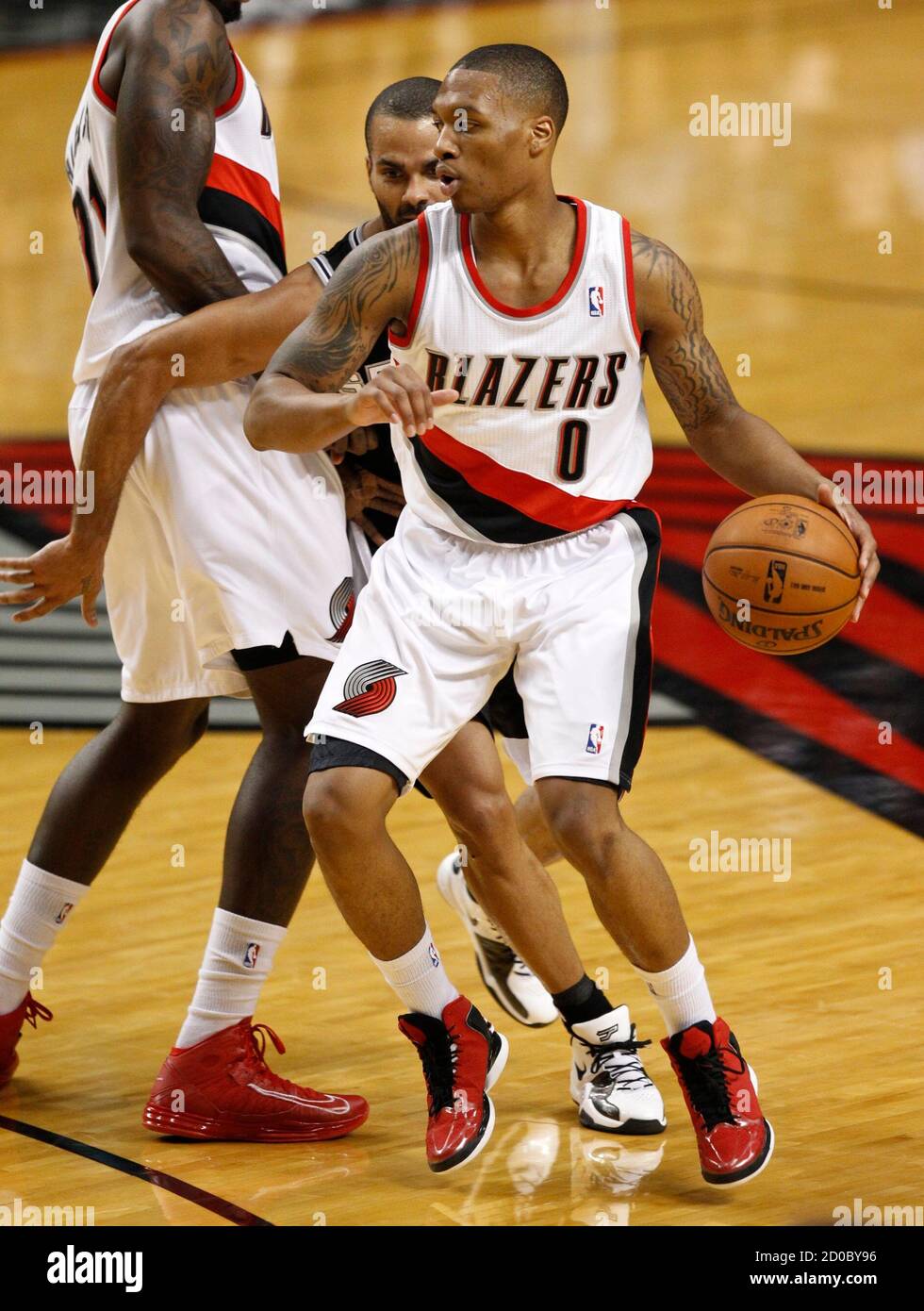 Portland Trail Blazers Point Guard Damian Lillard 0 Dribbles Against San Antonio Spurs Point Guard Patty Mills 8 During Third Quarter Of Their Nba Basketball Game In Portland Oregon December 13 2012