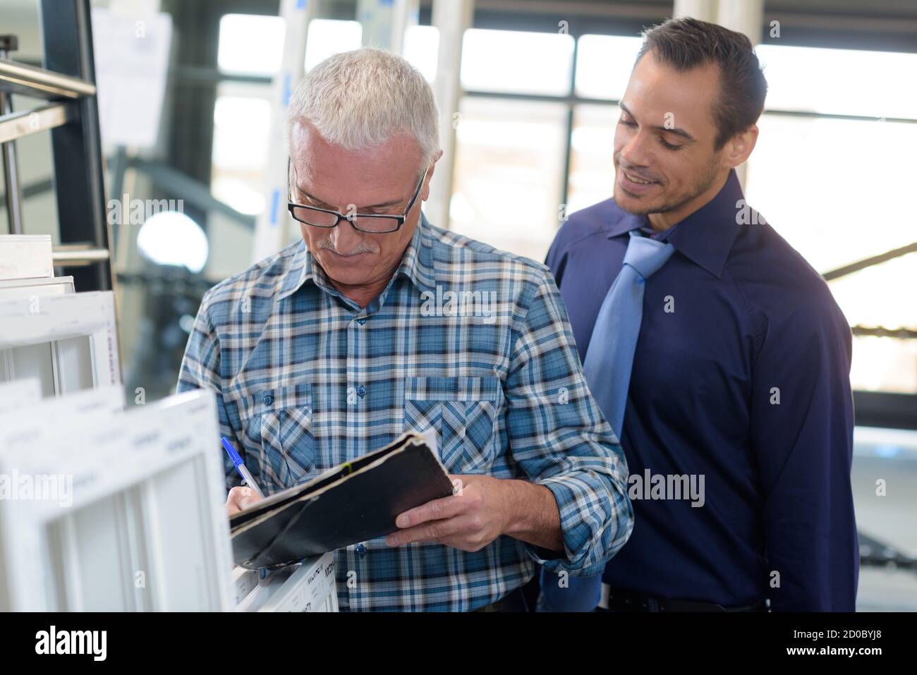 two worker in factory on the machine Stock Photo - Alamy