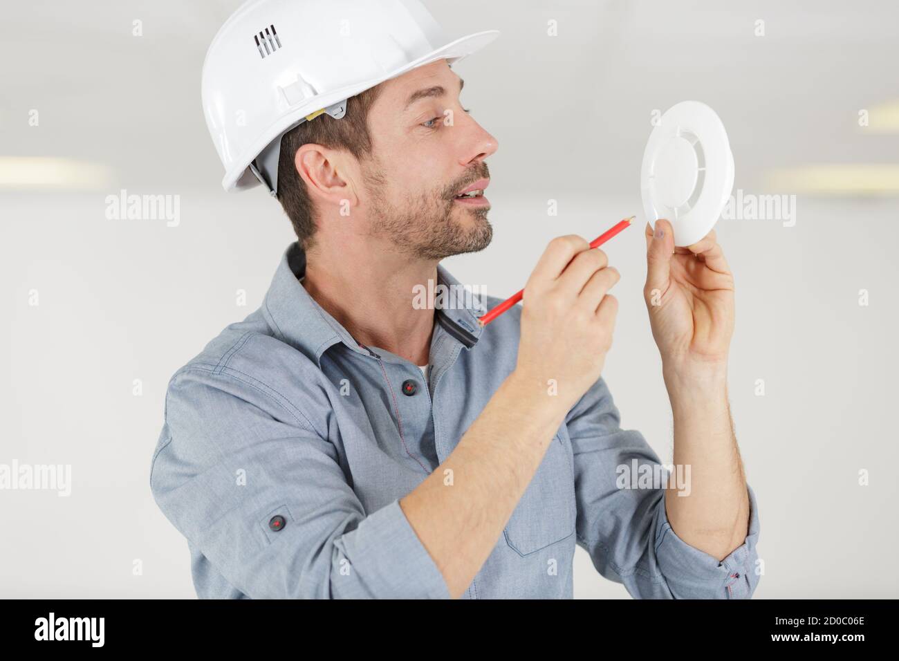 electrician installing fire alarm system Stock Photo Alamy