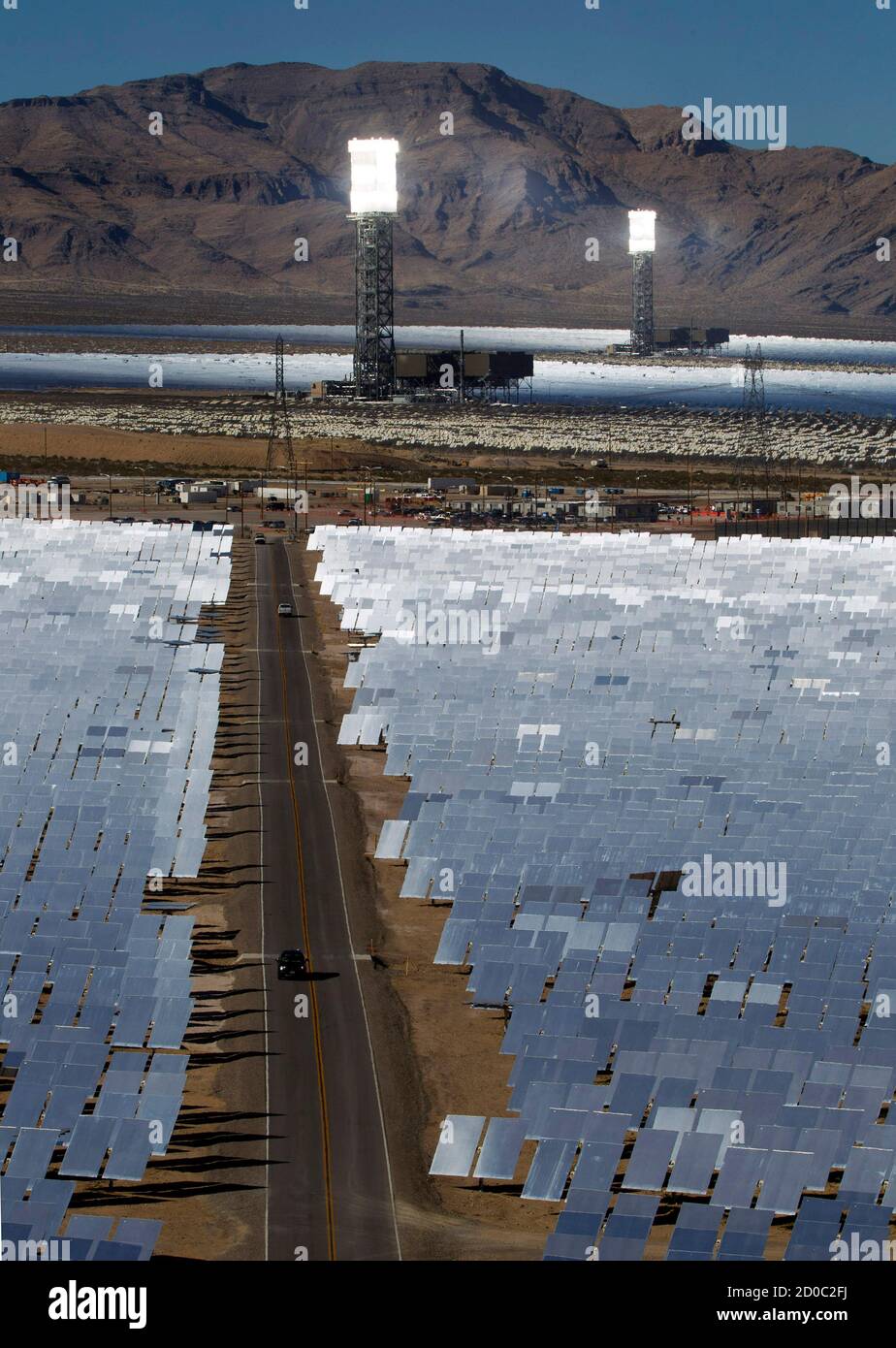 Heliostats reflect sunlight onto boilers in towers during the grand opening of the Ivanpah Solar Electric Generating System in the Mojave Desert near the California-Nevada border February 13, 2014. The project, a partnership of NRG, BrightSource, Google and Bechtel, is the world's largest solar thermal facility and uses 347,000 sun-facing mirrors to produce 392 Megawatts of electricity, enough energy to power more than 140,000 homes. REUTERS/Steve Marcus (UNITED STATES - Tags: ENERGY SCIENCE TECHNOLOGY BUSINESS) Stock Photo