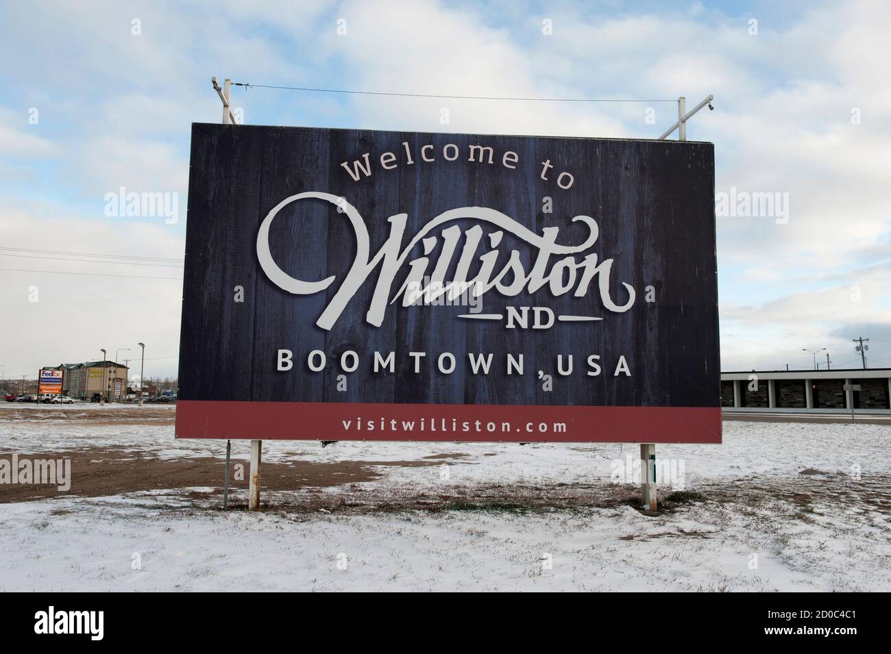 A sign reads 'Welcome to Williston ND Boomtown USA' along the main road in Williston, North Dakota November 12, 2014.  Falling oil prices have yet to spoil North Dakota's party, with billions of investment dollars still flowing for new wells and pipelines, apartments and shopping centers, a tacit bet the third energy boom in the state's history is just getting started.   REUTERS/Andrew Cullen (UNITED STATES  - Tags: BUSINESS COMMODITIES ENERGY) Stock Photo