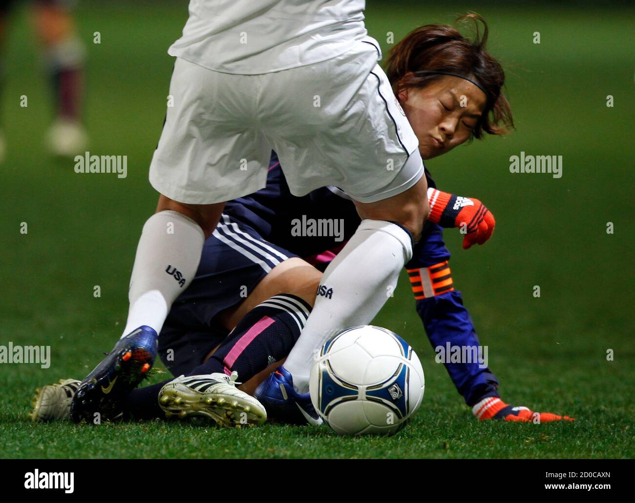 Aya Miyama (back) of Japan and Amy Lepeilbet of the U.S. fight for the ball during their women's friendly soccer match in Sendai, Miyagi prefecture, April 1, 2012. World Cup holders Japan were held 1-1 by the United States in a women's soccer friendly on Sunday, failing in their bid to beat the Olympic champions for the third time running. REUTERS/Issei Kato (JAPAN - Tags: SPORT SOCCER) Stock Photo
