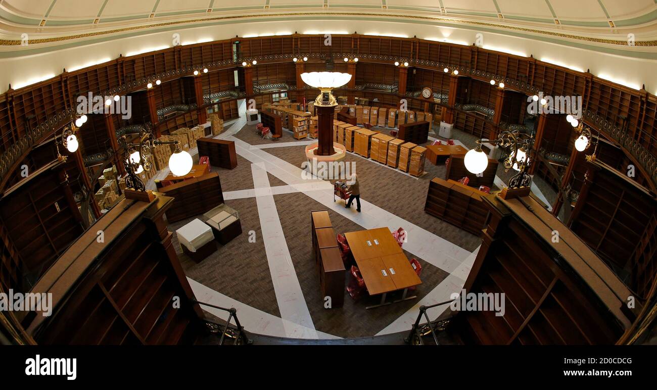Librarian Bern Bouffler pushes a trolley of books across the floor of the Picton reading room of the newly restored Central Library in Liverpool, northern England January 23, 2013. Four million items are being returned to the library which will open in May, following its two year restoration programme at a cost of 55 million GBP ($87 million). REUTERS/Phil Noble (BRITAIN - Tags: SOCIETY EDUCATION) Stock Photo