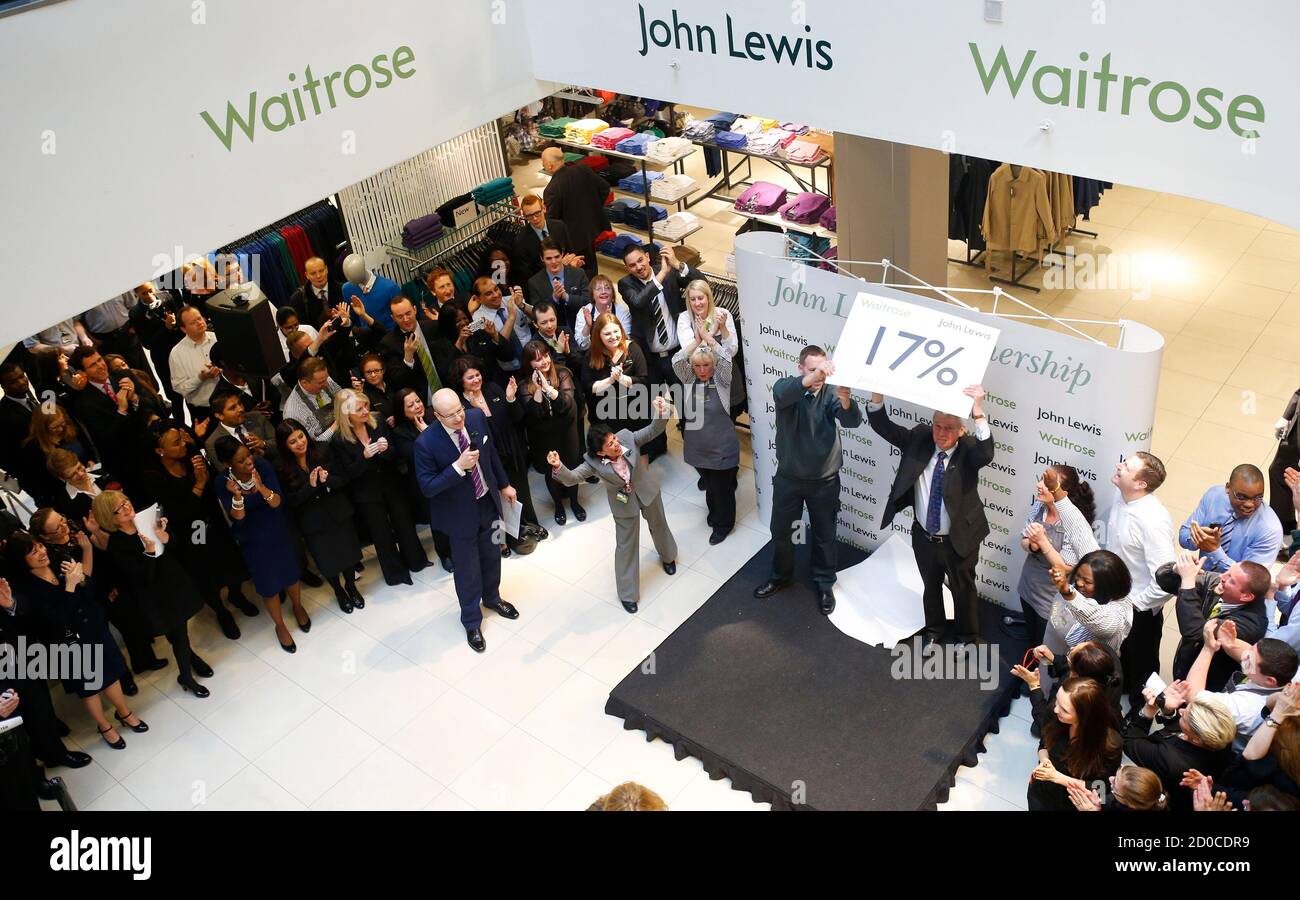 Workers, known as partners at the John Lewis Partnership, celebrate as  their annual profit related bonus is announced by the manager, at their  flagship Oxford Street store in central London March 7,