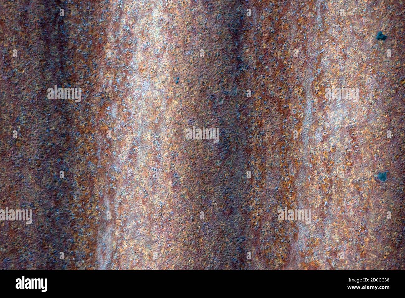 Abstract red texture background on tin metal sheet with rust patterns, close up view. Stock Photo