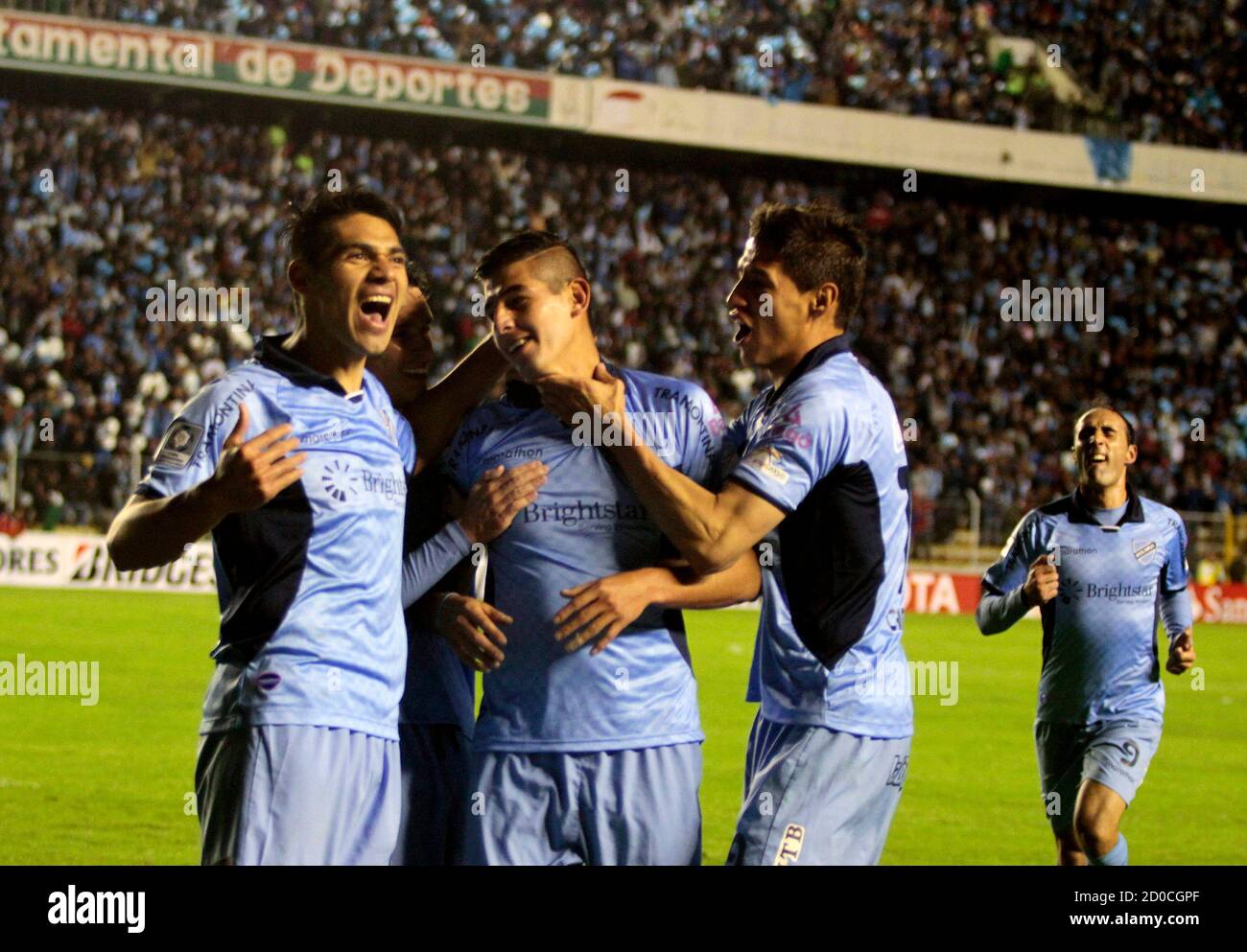 Ronald Eguino (C) of Boliva's Bolivar celebrates with teammates Luis Gutierrez (L) and Nelson Cabrera after scoring a goal against Mexico's Leon during their Copa Libertadores soccer match in La Paz, April 22, 2014. REUTERS/Gaston Brito (BOLIVIA - Tags: SPORT SOCCER) Stock Photo