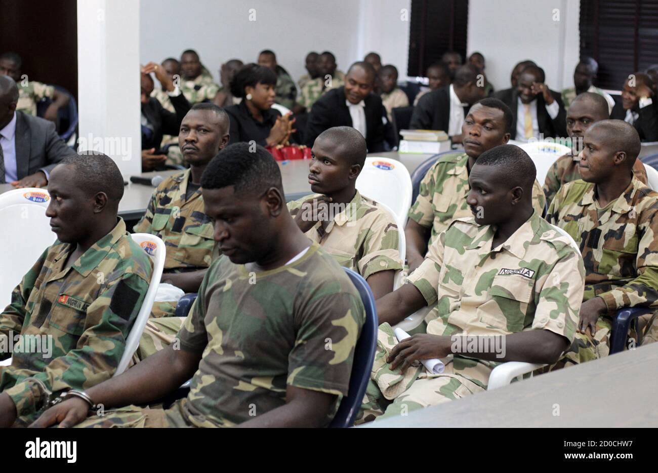 Nigeria soldiers appear before the general court-martial in Abuja October 2, 2014. Nigeria's military court-martialled 97 of its troops on Thursday for offences including mutiny, assault, absconding, house breaking and disorderly behaviour, it said.The president of the court-martial, Brigadier General Musa Yusuf, did not explicitly state that the trials related to soldiers' conduct in a war against Islamist insurgents Boko Haram, but the troops were all serving in Maiduguri in the northeast, epicentre of the conflict. REUTERS/Afolabi Sotunde (NIGERIA - Tags: MILITARY CRIME LAW) Stock Photo