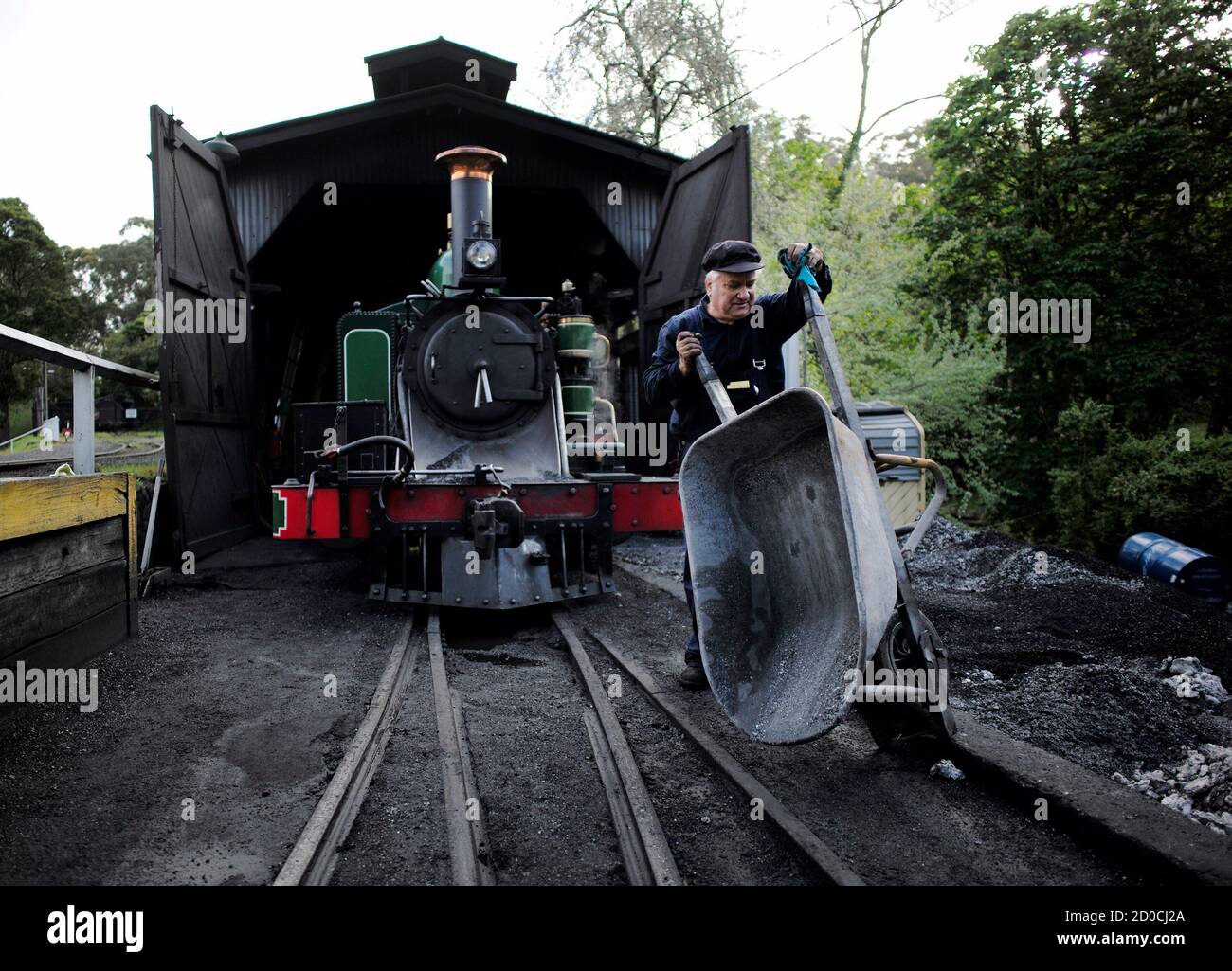 Puffing Billy steam engine driver Steve Holmes empties a wheelbarrow of ash  removed from the smokebox of locomotive 6A as he prepares to retire the  engine for the night in its shed