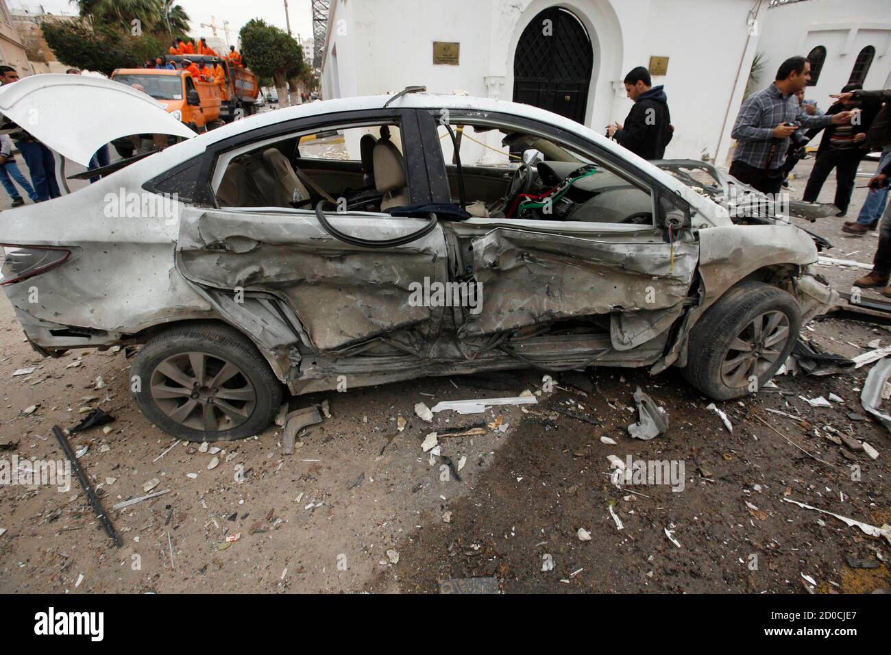 A damaged vehicle is seen at the scene of an explosion outside the 