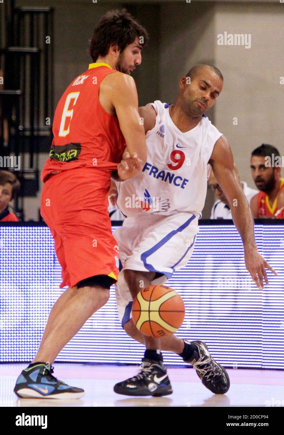 France's Tony Parker (R) is blocked by Spain's Ricky Rubio on the way to  the basket during their friendly match ahead of the upcoming Eurobasket  2011 championships in the southern Spanish city