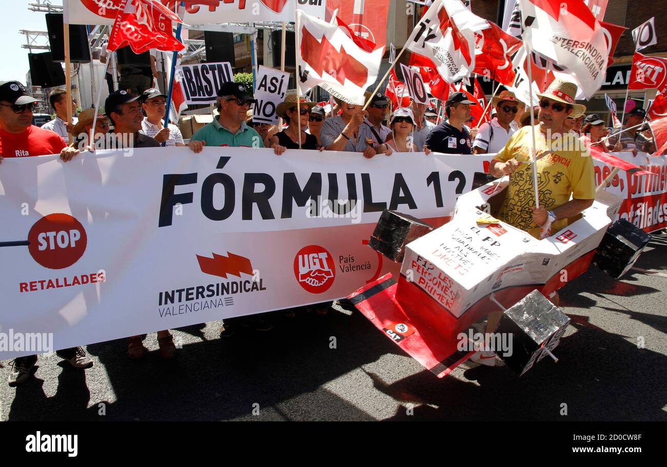 Demonstrators hold banners during a demonstration against the European F1 Grand Prix and cuts in public services in Valencia June 24, 2012. Trade unions called for the demonstration claiming 'the Formula One race is a great squandering of money'. REUTERS/Heino Kalis (SPAIN  - Tags: SPORT MOTORSPORT BUSINESS CIVIL UNREST POLITICS) Stock Photo
