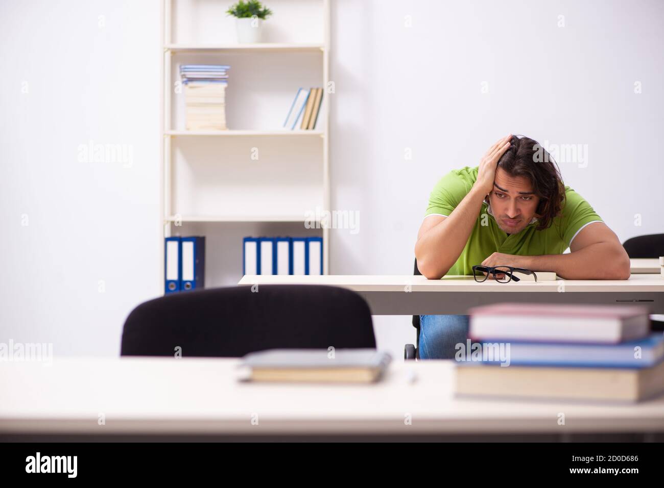 Young male student in the classroom studying Stock Photo - Alamy