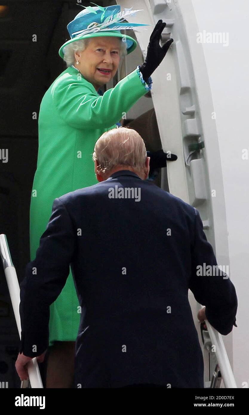 Britain's Queen Elizabeth waves as she boards an aircraft with Prince Philip at Cork Airport in Cork May 20, 2011. Large crowds cheered Queen Elizabeth for the first time on her historic visit to Ireland on Friday, as police relaxed security for the final day of a bridge-building mission widely seen as a success. After an arrival marred by bomb scares and a riot by people opposed to Britain's continuing control of Northern Ireland, police appeared to ease security to allow thousands of people within yards of the monarch for the first time.  REUTERS/Maxwell's/POOL   (IRELAND - Tags: POLITICS RO Stock Photo