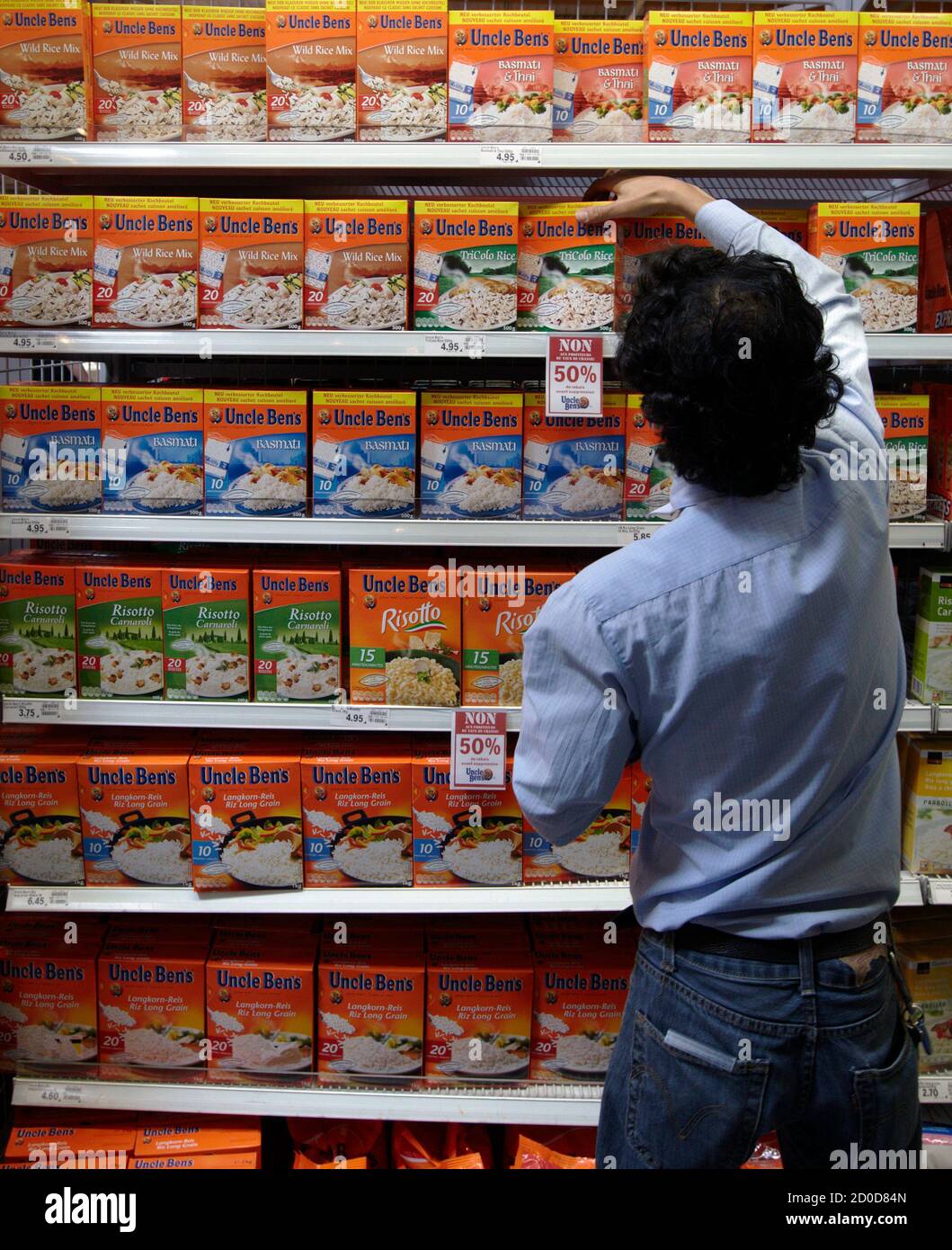 an employee arranges packets of rice at the leman shopping centre in crissier near lausanne august 15 2011 switzerland s second largest retail group coop said on sunday that they will stop selling certain