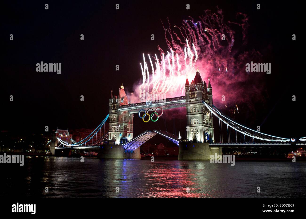 Fireworks explode off the Tower Bridge during the night of the opening ceremony of London 2012 Olympic Games in London July 27, 2012. REUTERS/Mark Blinch (BRITAIN - Tags: SPORT OLYMPICS) Stock Photo
