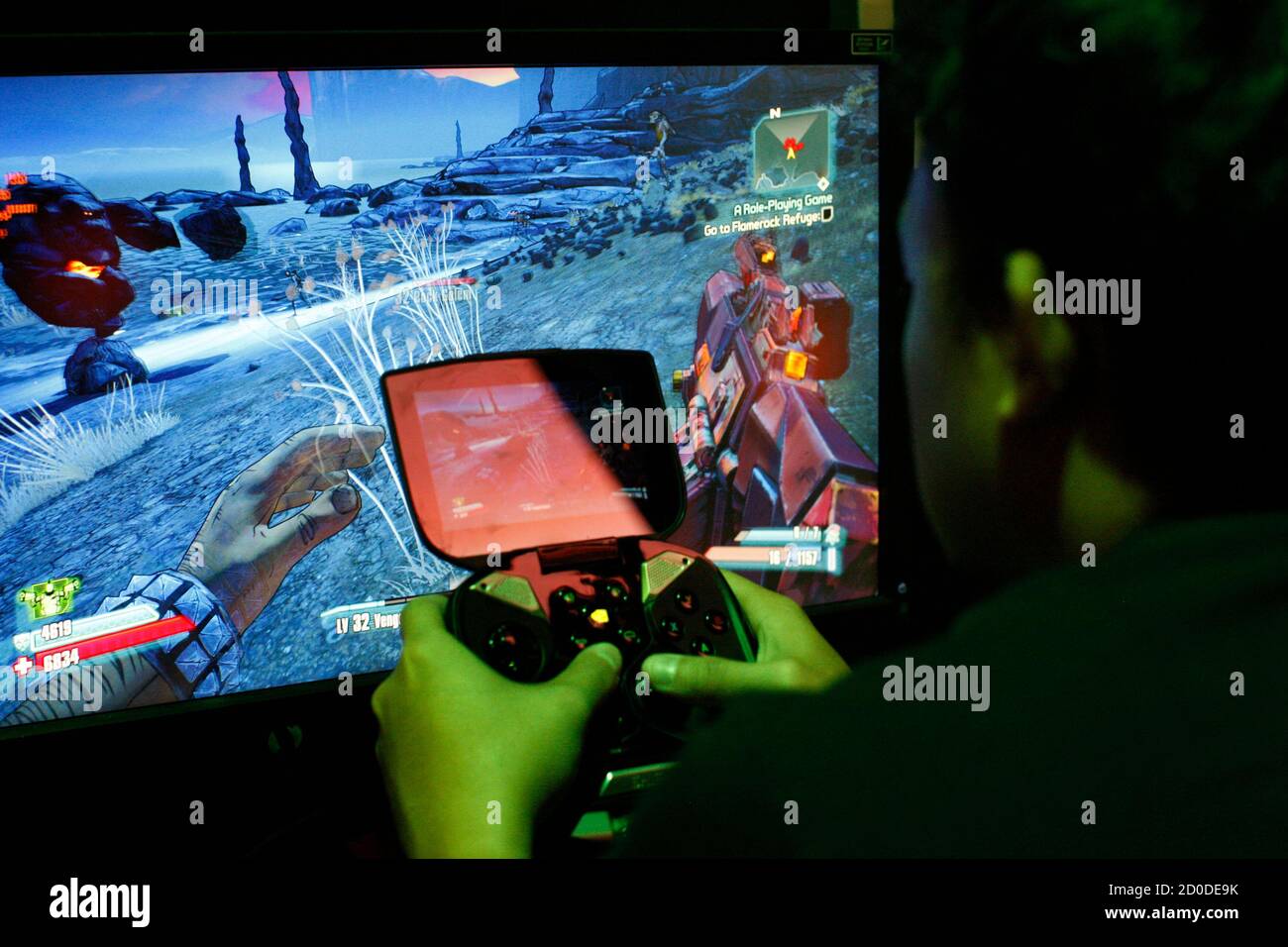 A man tries a game at the Nvidia Shield PC Game Streaming exhibit at E3, the Electronic Entertainment Expo, in Los Angeles, California, June 11, 2013.    REUTERS/David McNew (UNITED STATES - Tags: SCIENCE TECHNOLOGY SOCIETY BUSINESS) Stock Photo