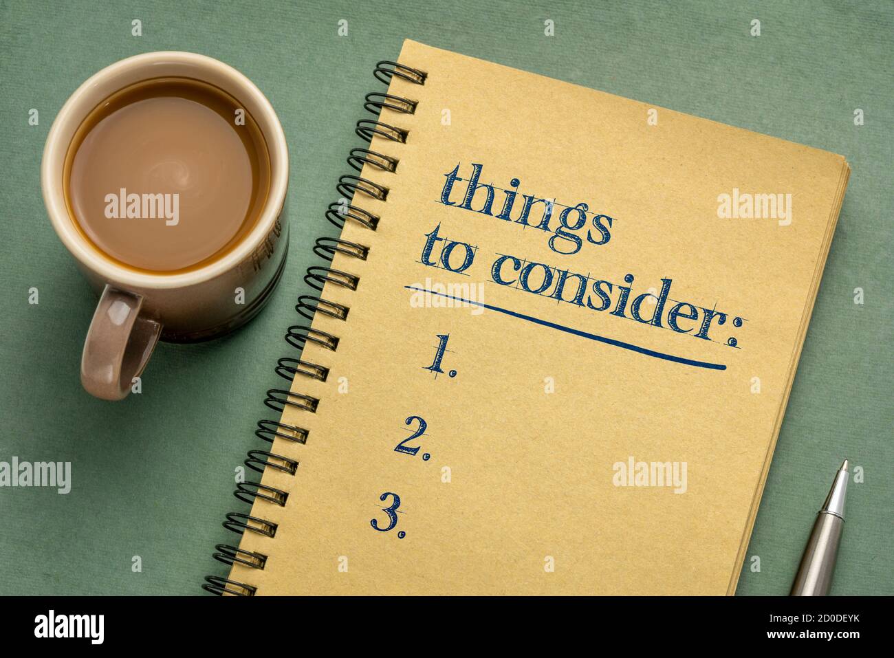 things to consider list - handwriting in a notebook with a cup of coffee, business planning concept Stock Photo