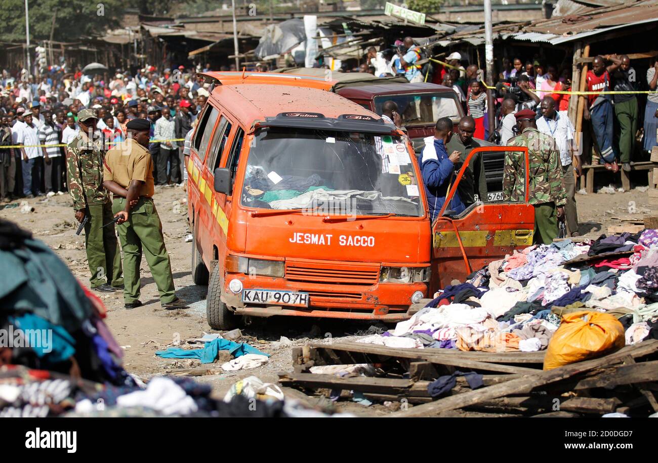 Policemen inspect a damaged public transport van wrecked at the scene of a twin explosion at the Gikomba open-air market for second hand clothes in Kenya's capital Nairobi May 16, 2014. The death toll in twin blasts on Friday in the Kenyan capital Nairobi rose to at least 10 with close to 70 people wounded, the National Disaster Operations Centre said. REUTERS/Thomas Mukoya (KENYA - Tags: CIVIL UNREST CRIME LAW) Stock Photo