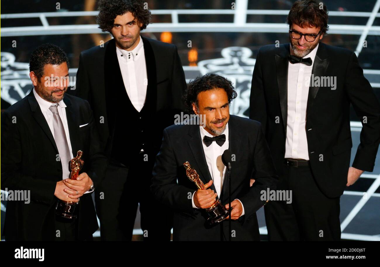 Alejandro G. Inarritu (2nd R)  speaks along with writers Alexander Dinelaris, Armando Bo, and Nicolas Giacobone (L-R), winners for best original screenplay for the film 'Birdman,'  at the 87th Academy Awards in Hollywood, California February 22, 2015.  REUTERS/Mike Blake (UNITED STATES TAGS:ENTERTAINMENT) (OSCARS-SHOW) Stock Photo