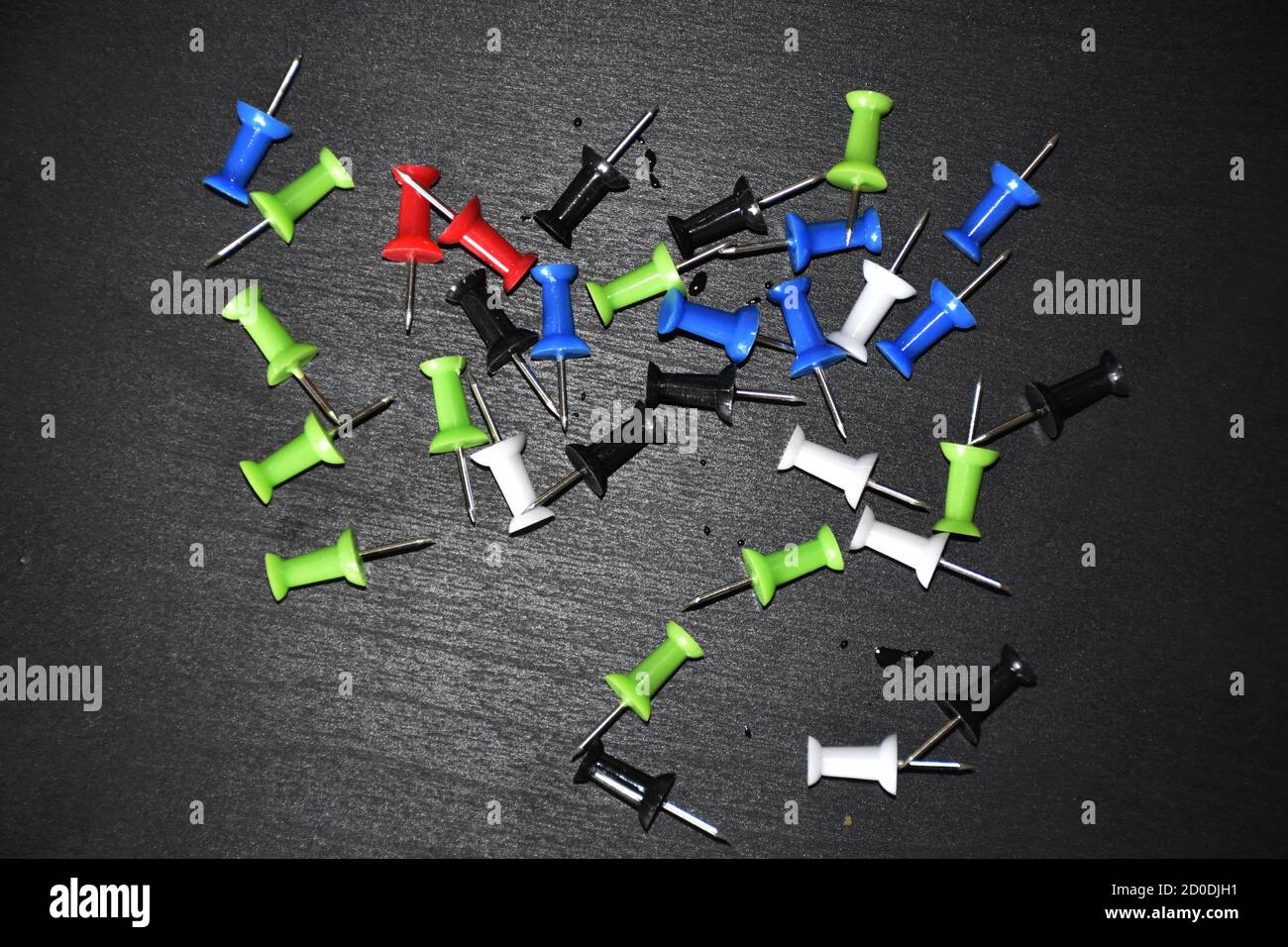 colorful punch pins drawing pins on black background Stock Photo Alamy