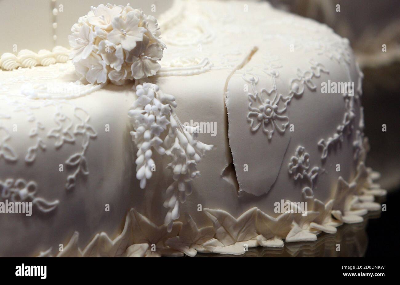 The first cut made in the royal wedding cake by Britain's Prince William and his wife Catherine, Duchess Cambridge is seen as an exhibition is prepared at Buckingham Palace in