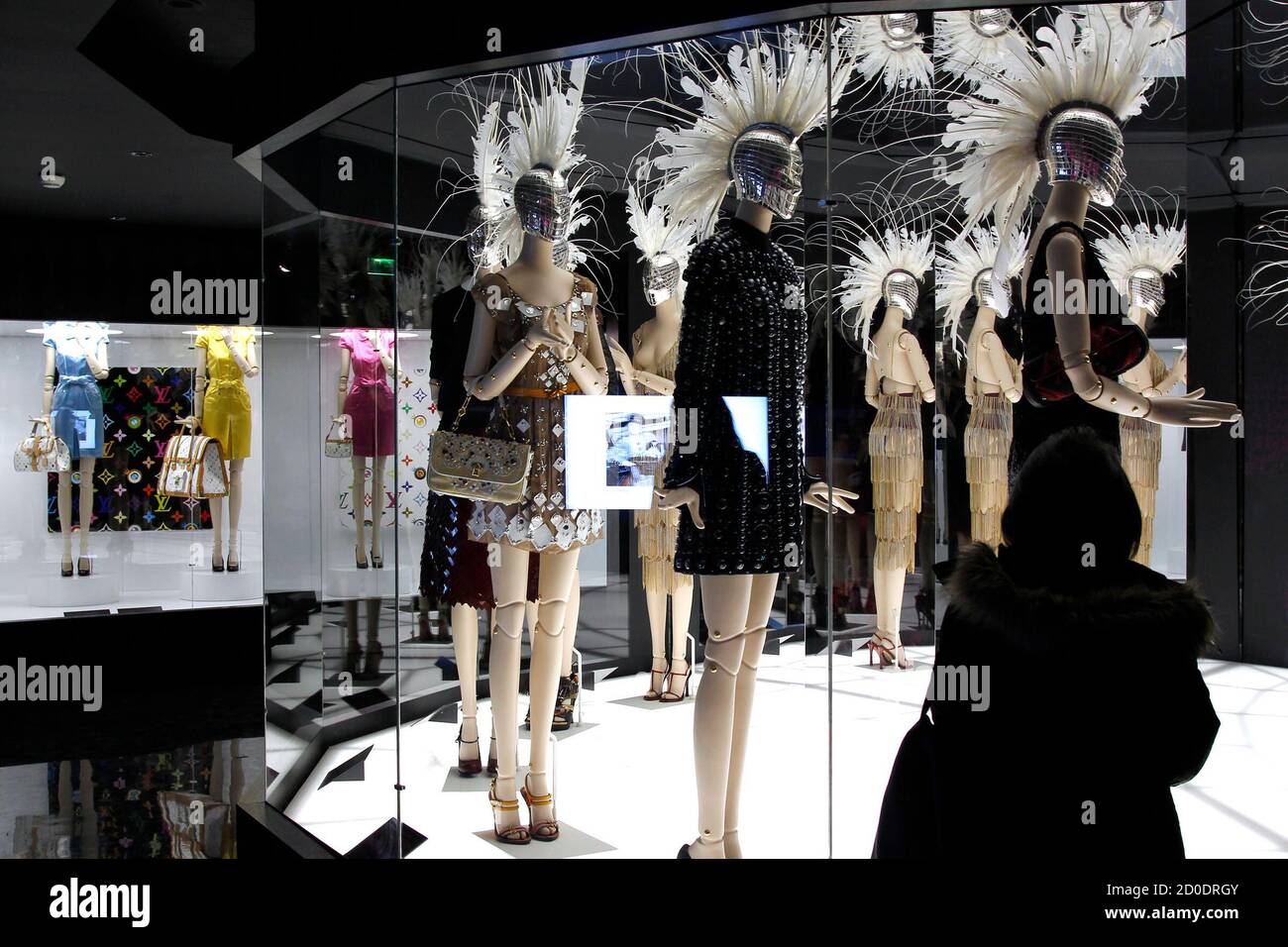 A visitor looks at fashion creations during the press presentation of the 'Louis  Vuitton - Marc Jacobs: The Exhibition' at the Museem of Decorative Arts in  Paris March 8, 2012. The exhibition,