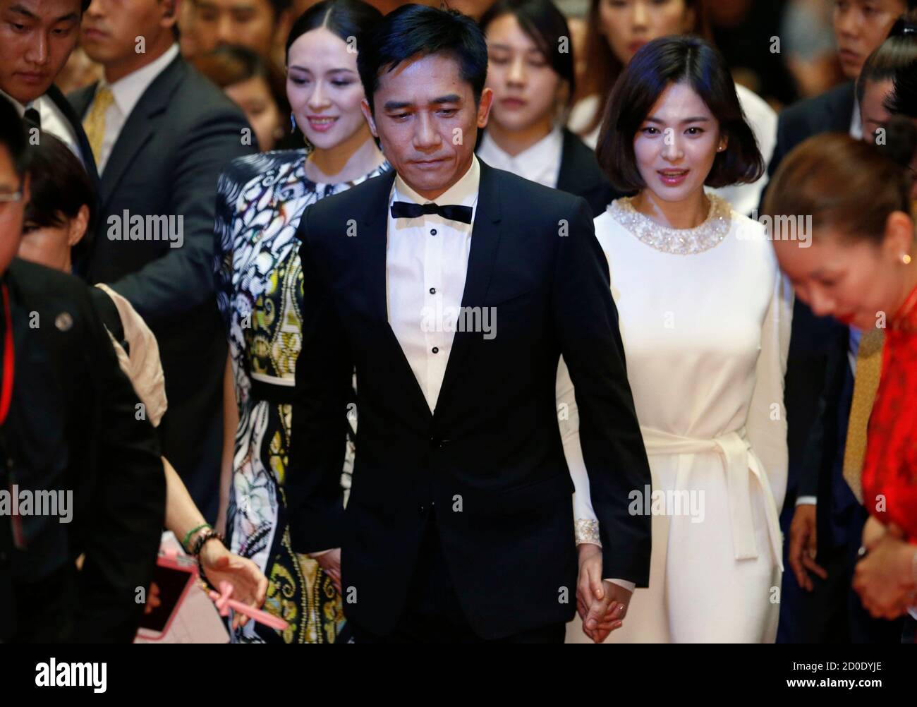 Cast members Tony Leung Chiu Wai (C), Zhang Ziyi (L) and Song Hye-kyo walk on the red carpet during an event promoting their movie 'The Grandmaster', the opening film of the Chinese Film Festival, in Seoul June 16, 2013. REUTERS/Kim Hong-Ji (SOUTH KOREA - Tags: ENTERTAINMENT) Stock Photo