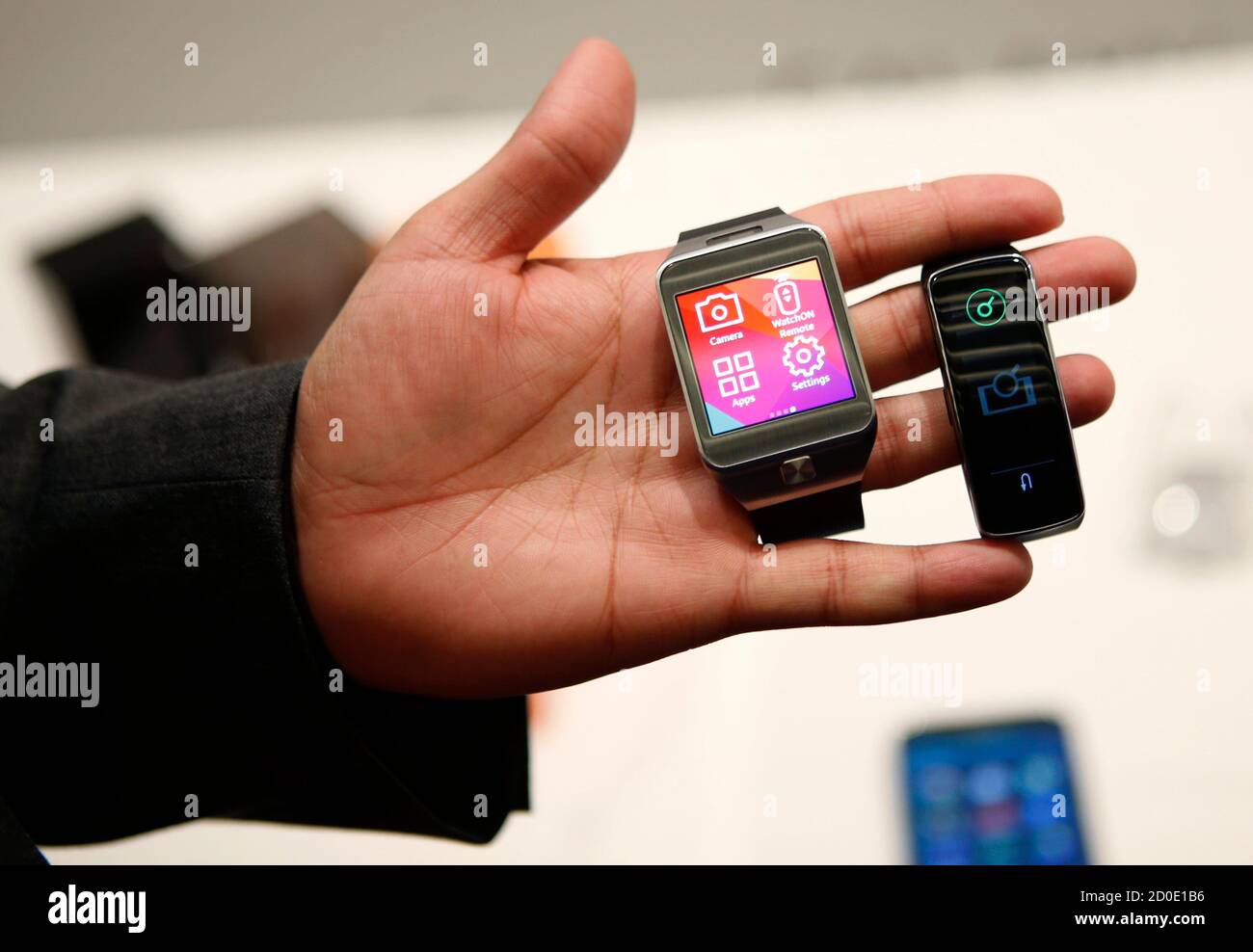 The new Samsung Gear 2 smartwatch (L) and Gear Fit fitness band are  displayed at the Mobile World Congress in Barcelona February 23, 2014.  Samsung Electronics unveiled a new smart watch and