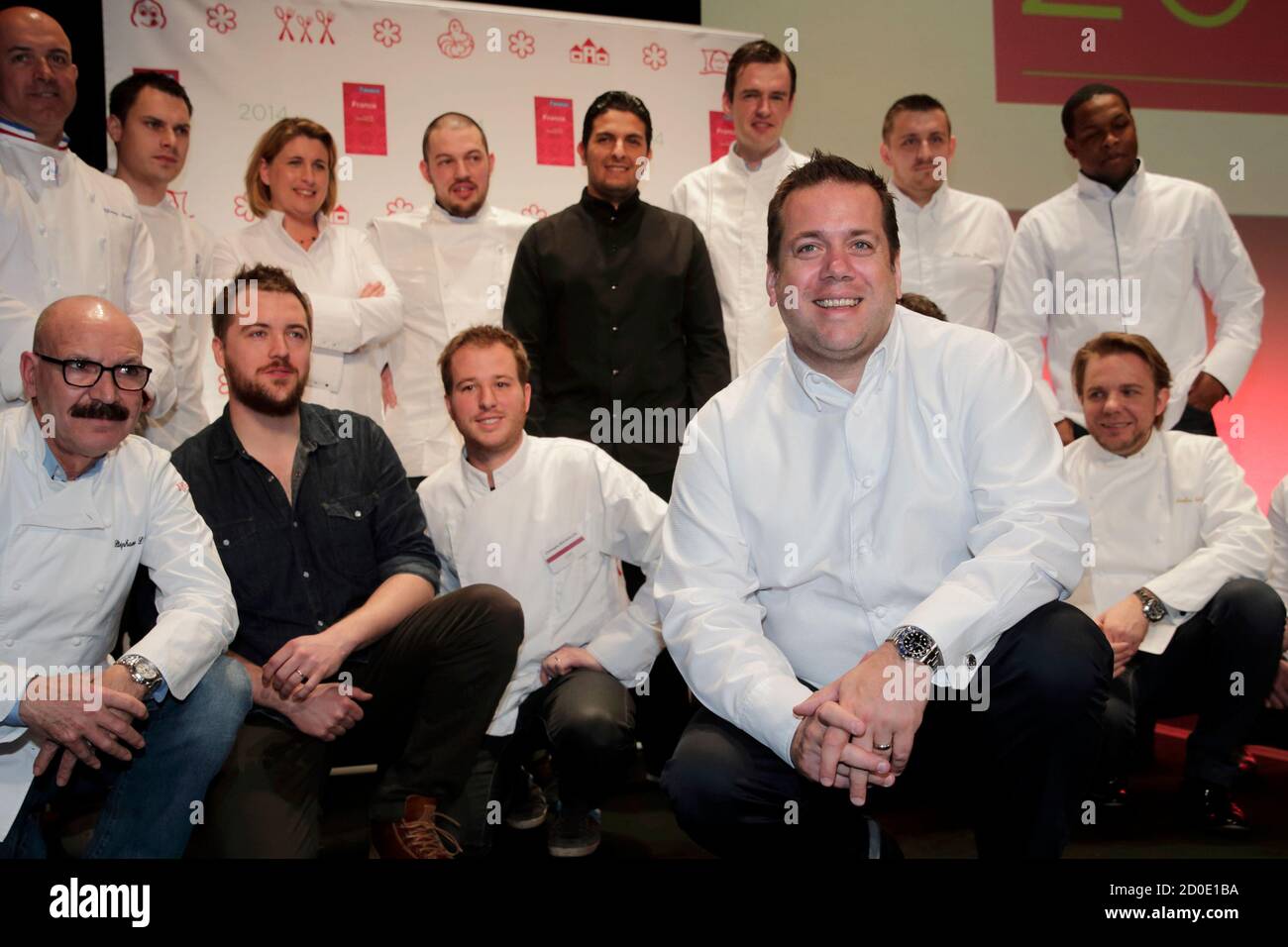 French chef Arnaud Lallement (front), new three-stars winner for his  restaurant L'Assiette Champenoise in Tinqueux, near Reims, poses amongst  newly promoted Chefs during the presentation of the new 2014 annual  Michelin restaurant