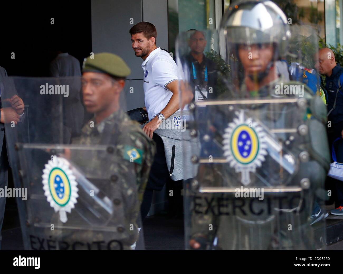 England's Steven Gerrard walks past Brazilian army personal as he arrives at the team hotel in Rio de Janeiro June 8, 2014. REUTERS/Eddie Keogh (BRAZIL - Tags: SPORT SOCCER WORLD CUP) Stock Photo