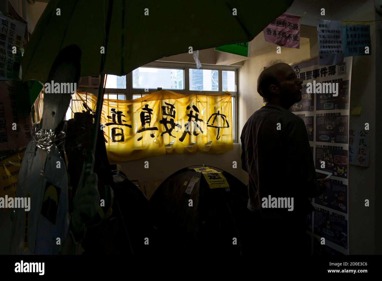 A protest banner reading 'I want real universal suffrage' collect from Occupy zone hangs on the window at a guesthouse in Hong Kong December 30, 2014. Set up in a small apartment in the Causeway Bay shopping district, the guesthouse that gives what it calls 'Umbrella Revolution Occupation Experience' charges guest HK$100 (US$13) a night to stay in a tent surrounded by pro-democracy banners, a cardboard cutout of Chinese President Xi Jinping holding a yellow umbrella, and serve with toilet paper printed with the face of embattled leader of Hong Kong chief executive Leung Chun-ying. REUTERS/Tyro Stock Photo